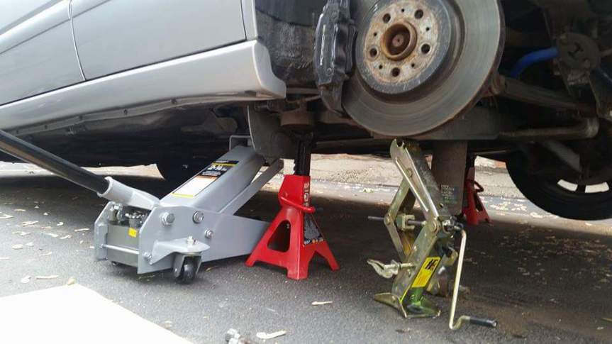 I used my oem jack ot lift the arm up. I bent it in the process but it was easy to get back into shape.