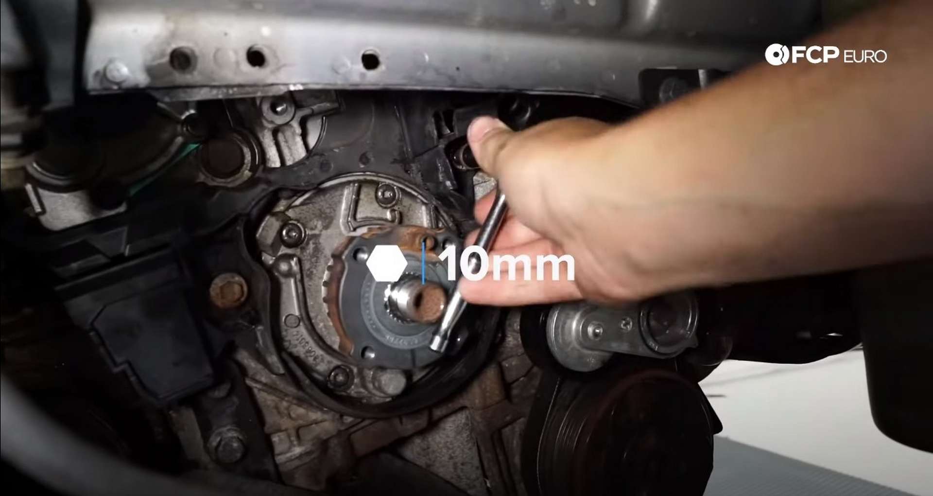 DIY Volvo P1 Water Pump Replacement installing the lower timing cover bolts