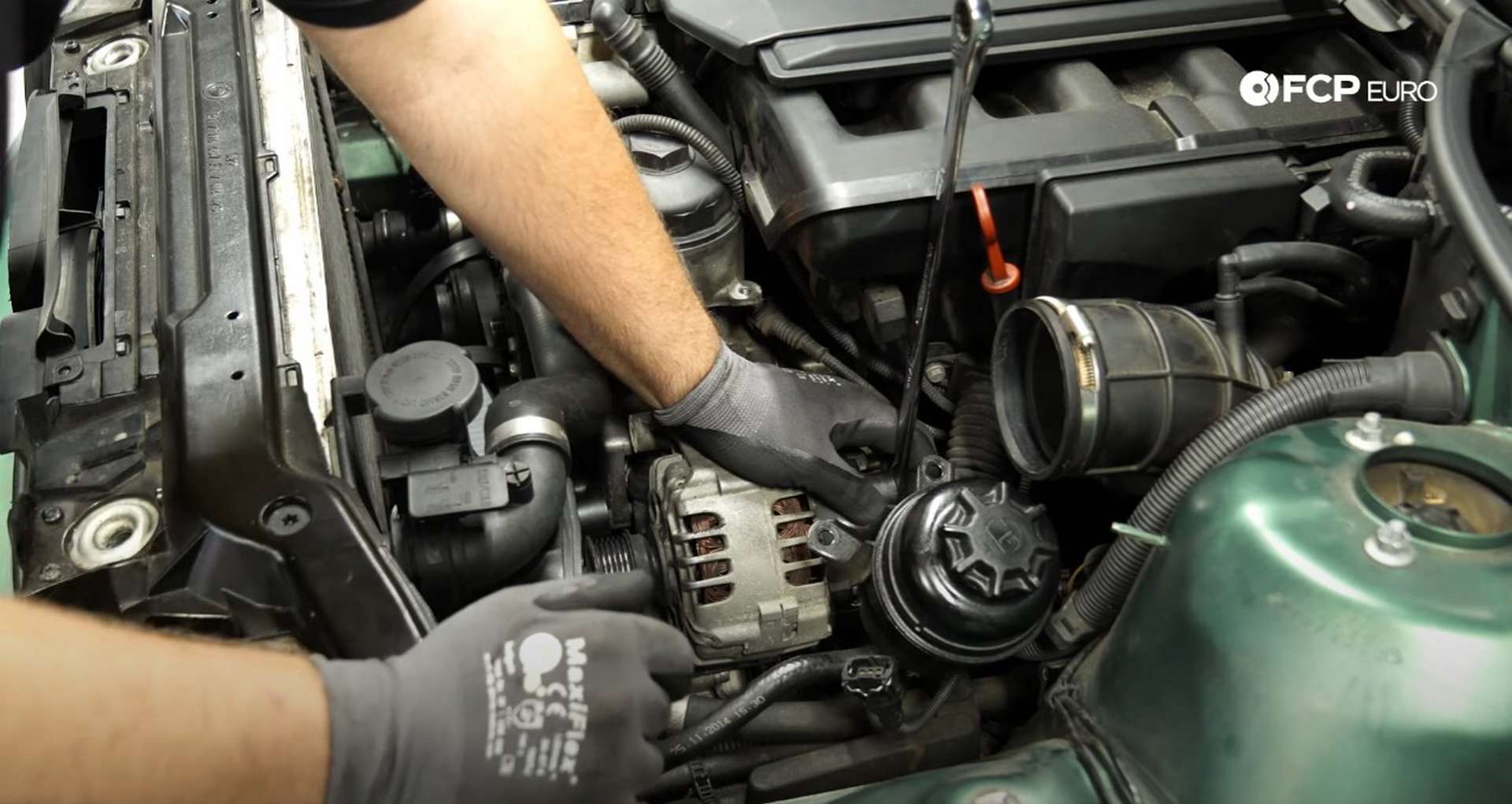 DIY BMW E46 Oil Filter Housing Gasket and VANOS Line Replacement removing the alternator's power lead nut