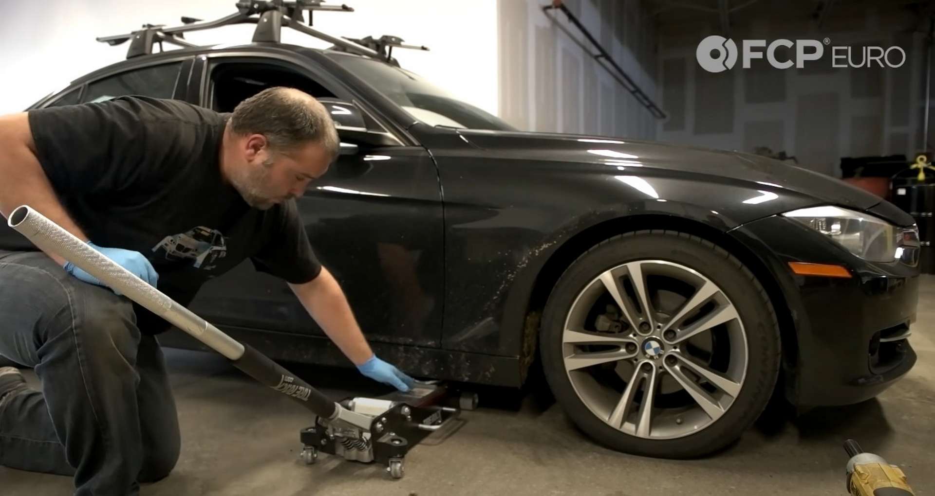 DIY BMW F30 Headlight Bulb Replacement lifting the car from the forward jack point