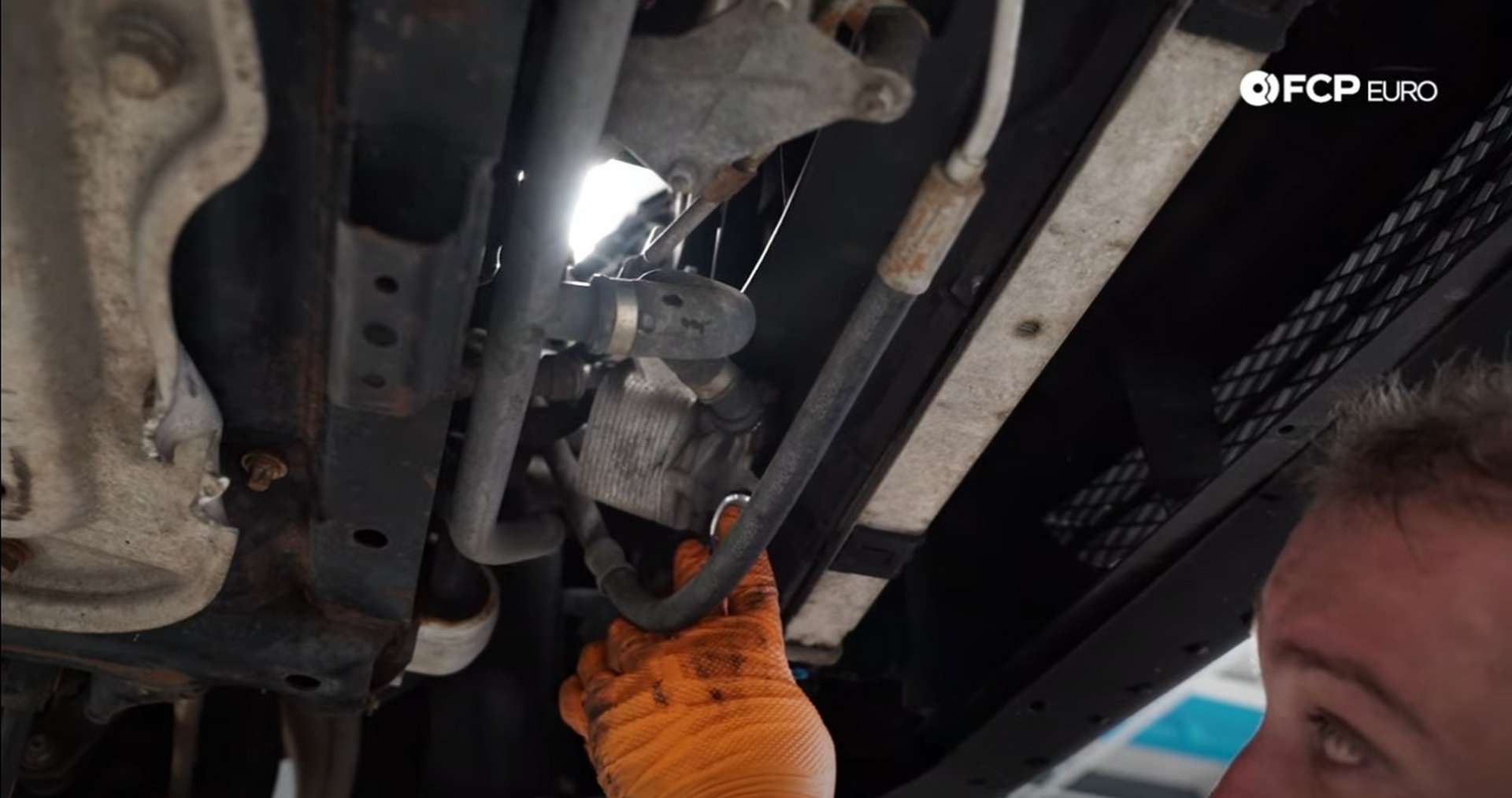 DIY BMW N52 Drive Belt Replacement removing the transmission oil cooler from the fan shroud