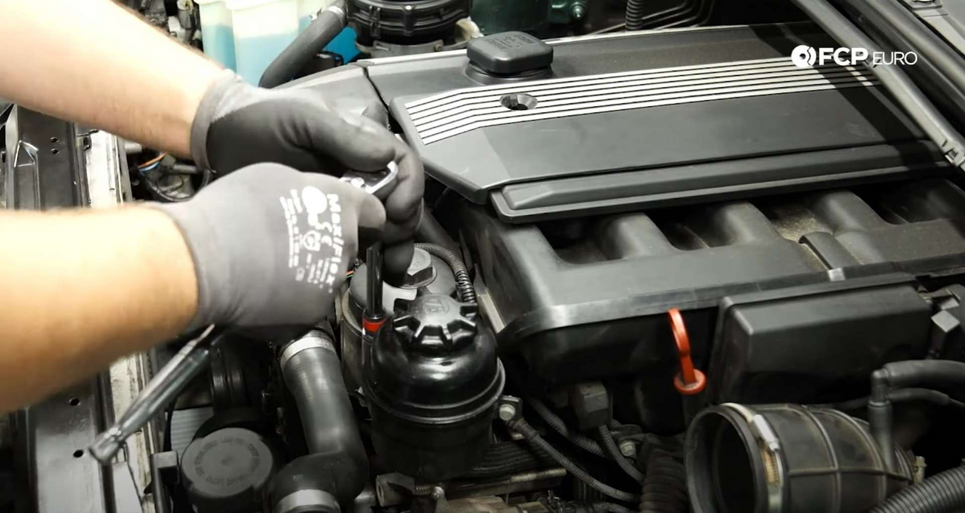 DIY BMW E46 Oil Filter Housing Gasket and VANOS Line Replacement removing the power steering reservoir bolts