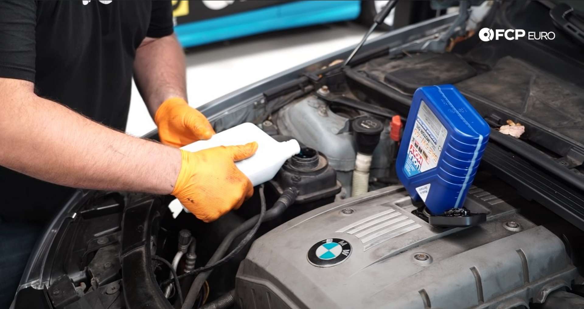 DIY BMW E9X Oil Filter Gasket Replacement filling the engine with coolant and oil