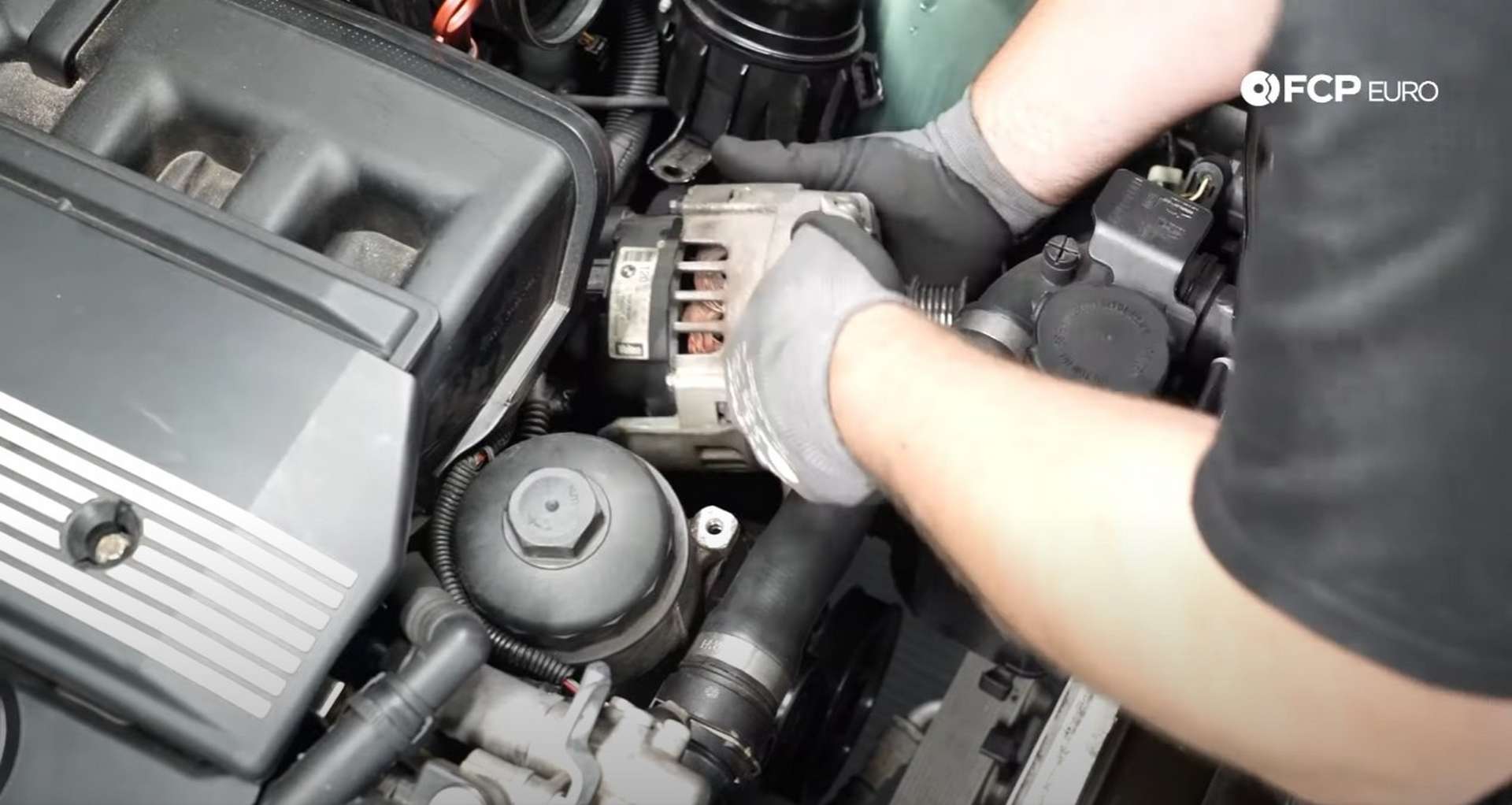 DIY BMW E46 Oil Filter Housing Gasket and VANOS Line Replacement removing the alternator