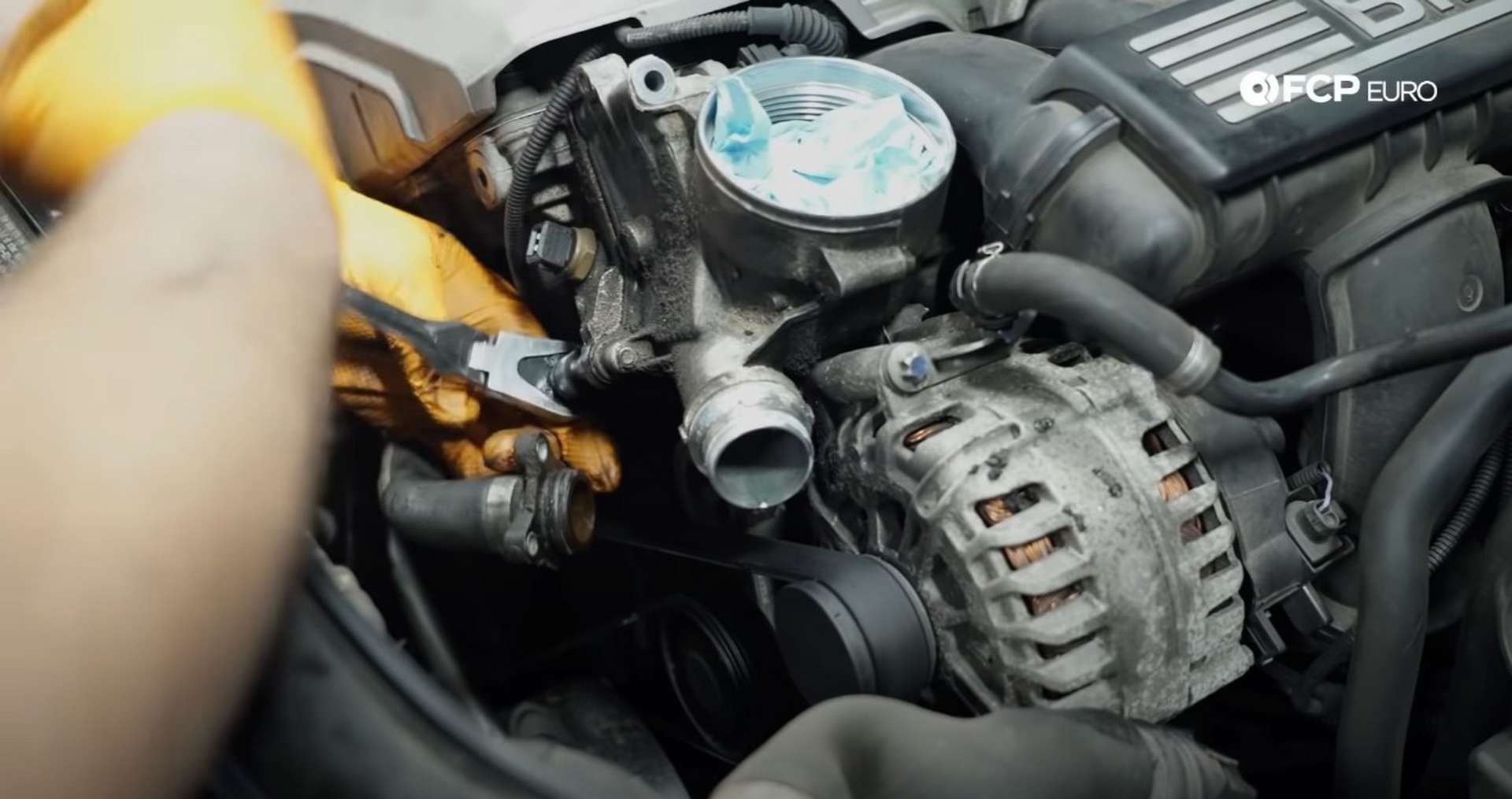DIY BMW E9X Oil Filter Gasket Replacement removing the housing's final mounting bolt
