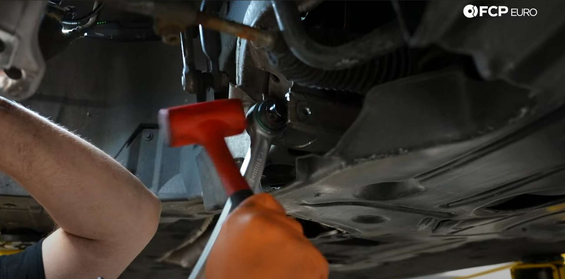 DIY BMW E9X Front Control Arm Upgrade hammering in the lower control arm’s inner pivot