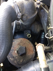 Pictured here (brass colored) is the tensioning nut that loosens or tightens the belt tension once the 19mm bolt is loosened.