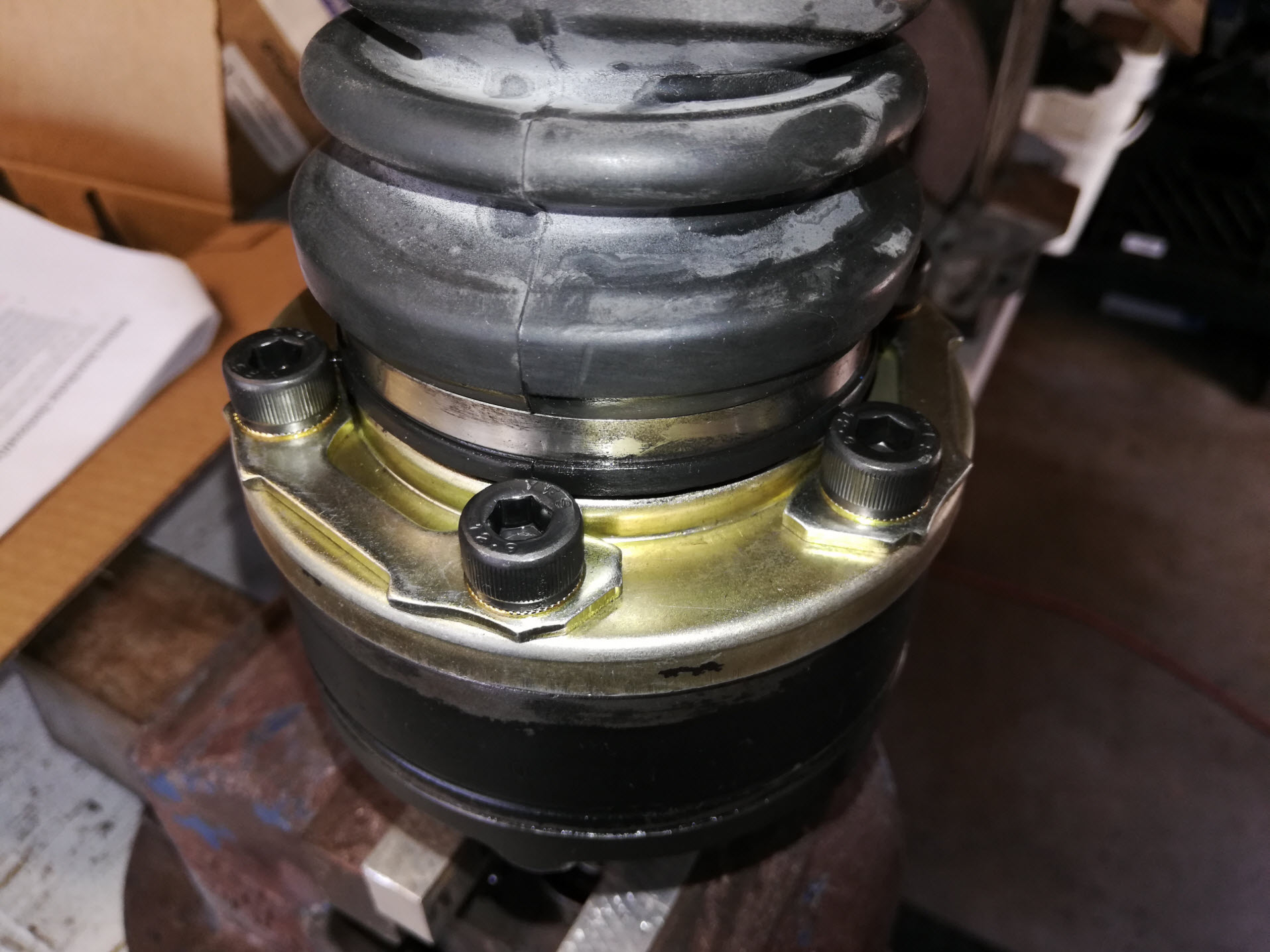 Air-cooled Porsche 911 outer CV joint and stub axle assembly on vise.