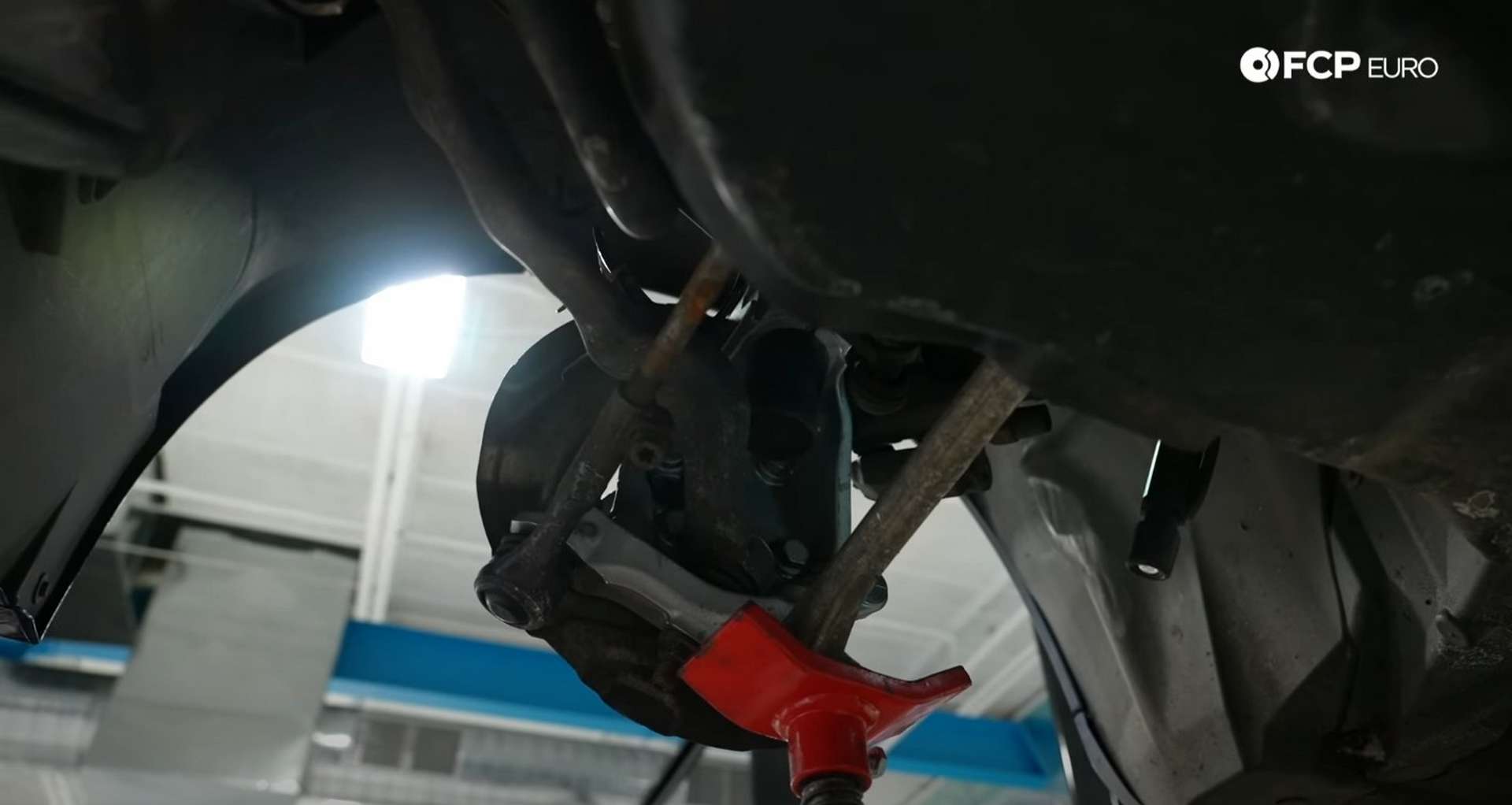 DIY BMW E9X Wheel Bearing Replacement jacking the knuckle into place