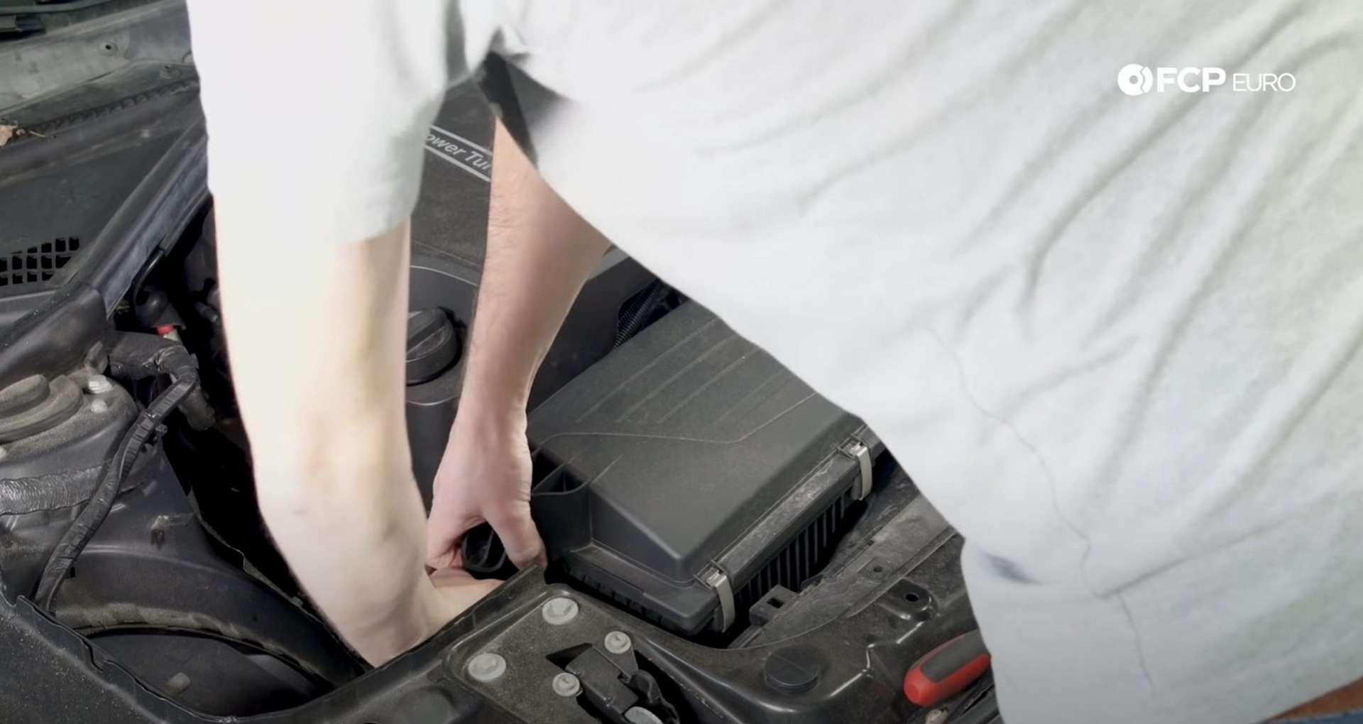 DIY BMW F30 Air Filter Replacement lifting the airbox cover off the grommets