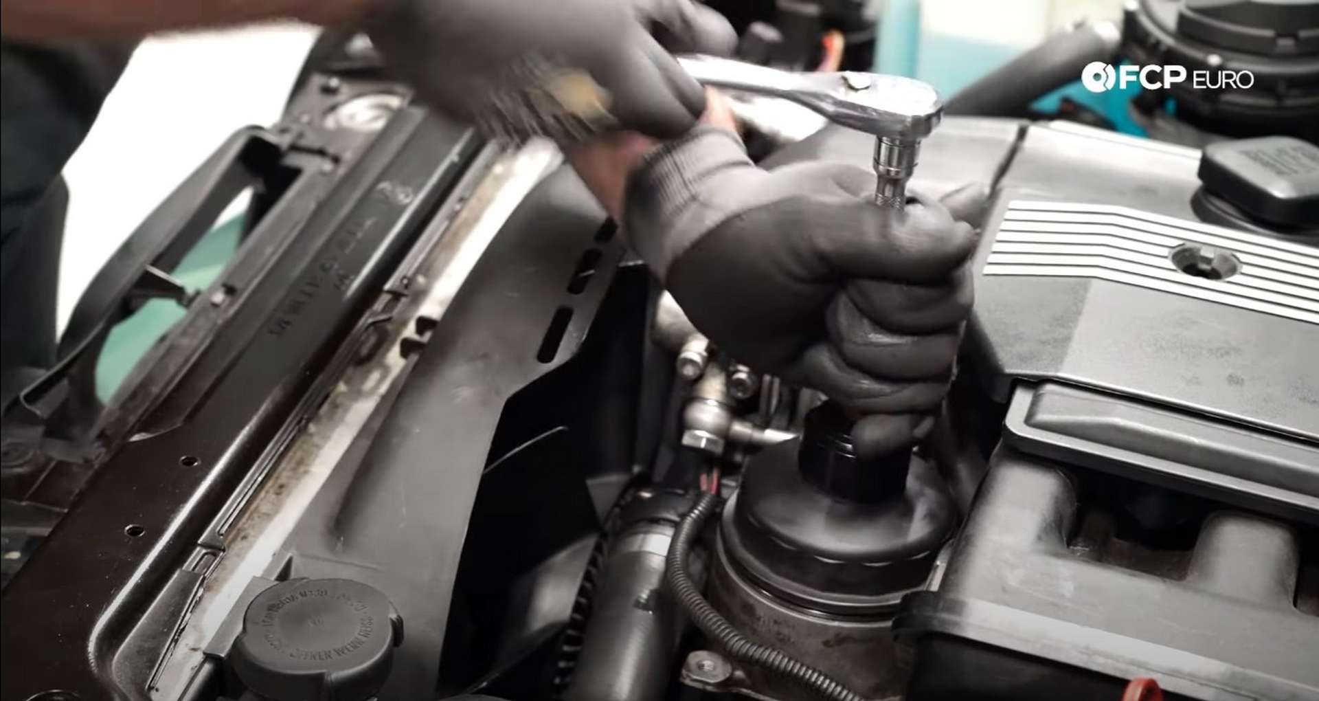 DIY BMW E46 Oil Filter Housing Gasket and VANOS Line Replacement tightening the oil filter housing cap
