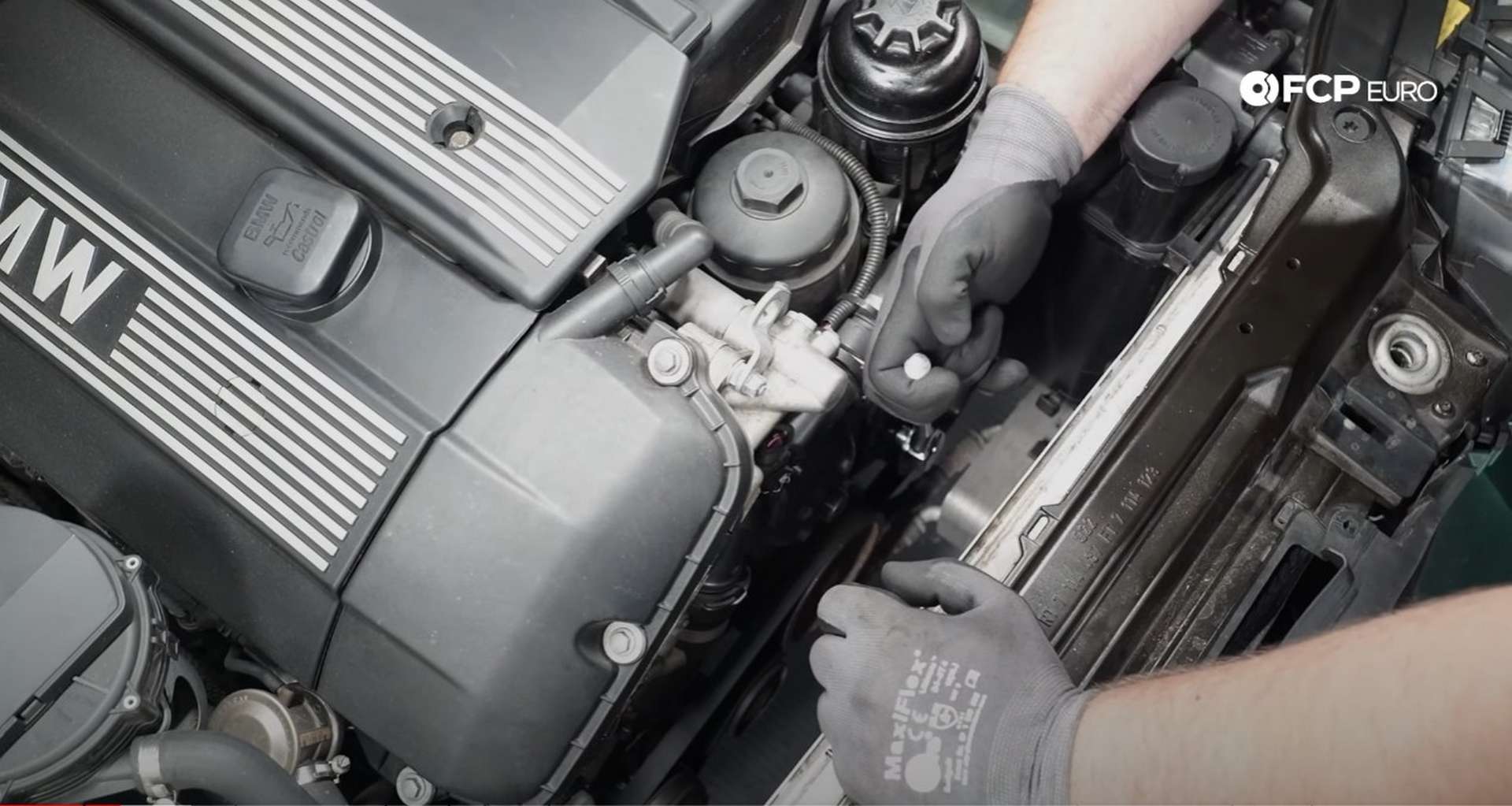 DIY BMW E46 Oil Filter Housing Gasket and VANOS Line Replacement removing the fan