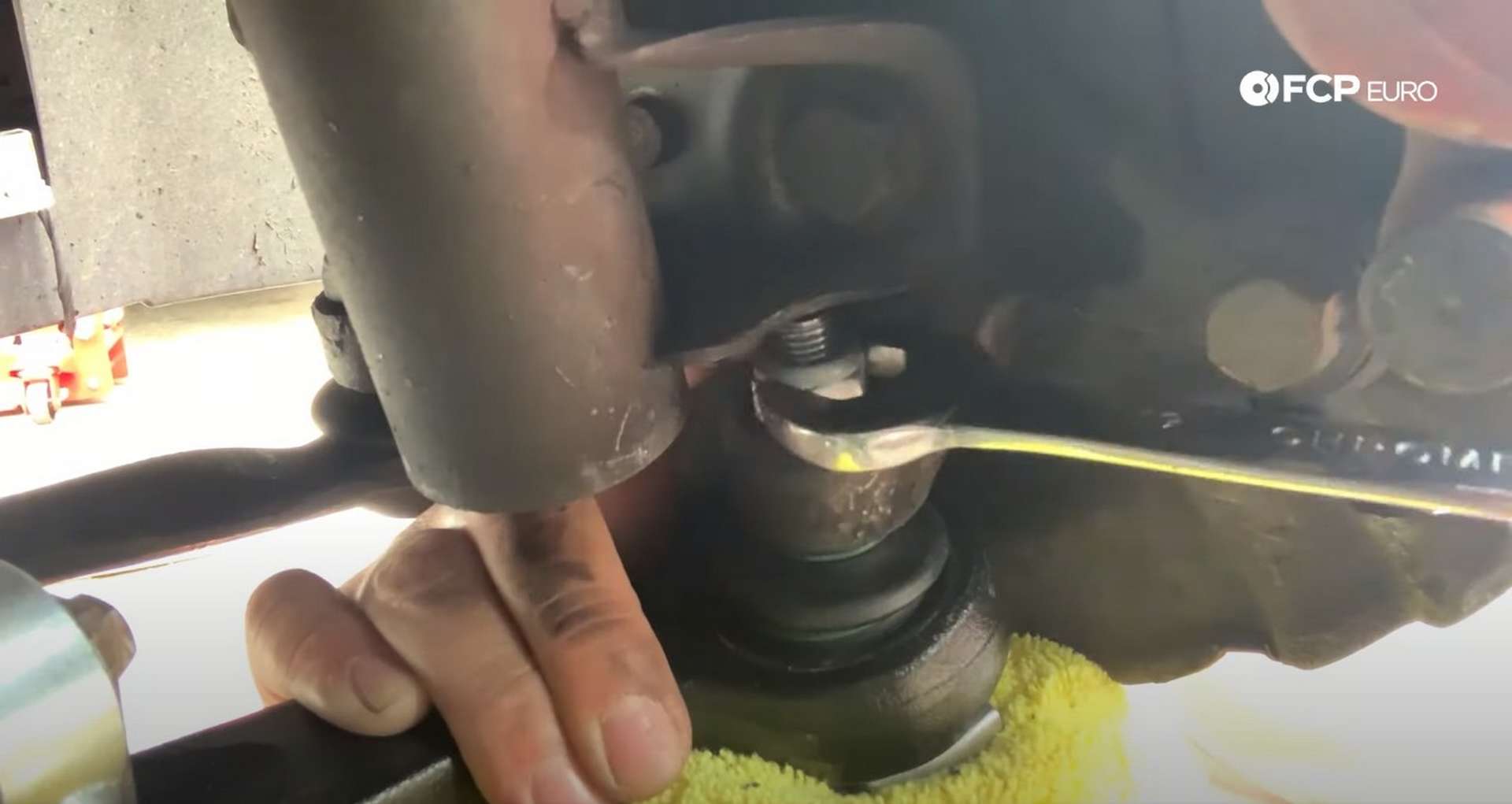 DIY BMW E36 Control Arm and Bushings using the jack to put pressure on the outer ball joint