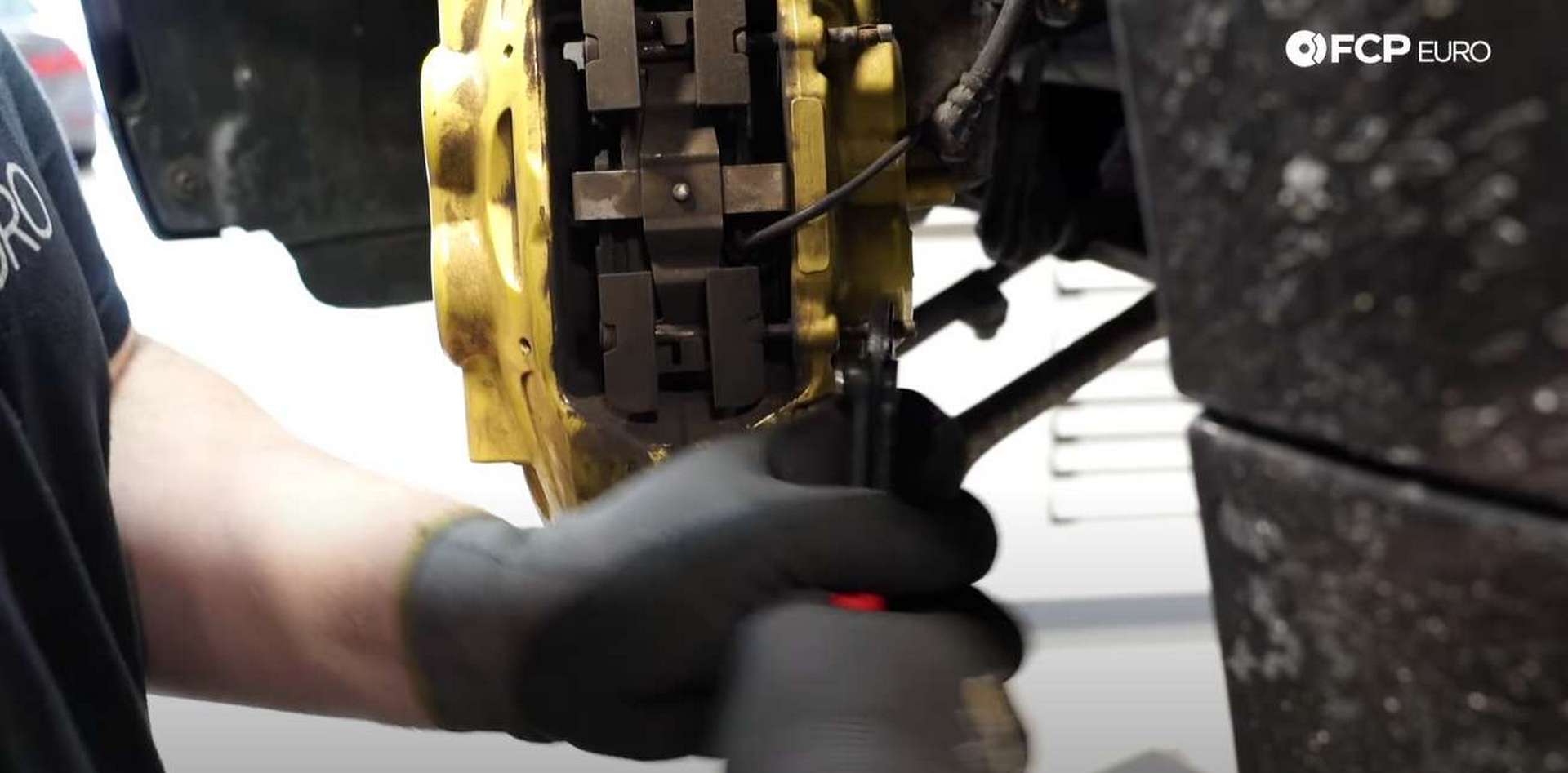 DIY BMW F30 M-Sport Brake Service using pliers to pull out the pad pins