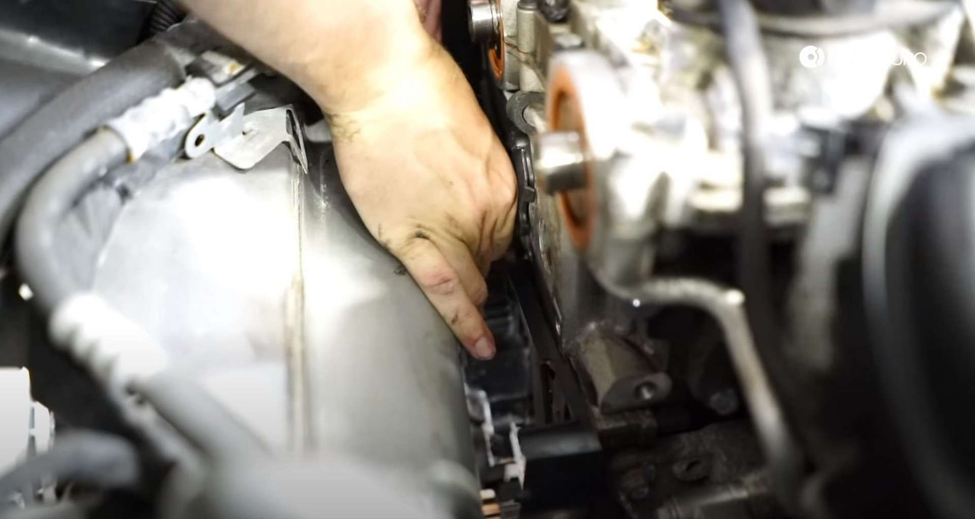 DIY Volvo P1 Water Pump Replacement installing the upper timing cover bolts