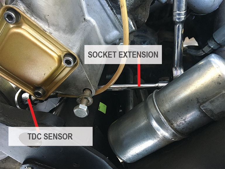 Socket wrench and extension in place to remove TCD sensor