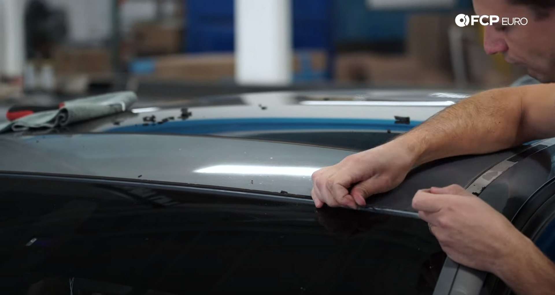 DIY BMW E9X Windshield Replacement picking off the remaining bits of the seal