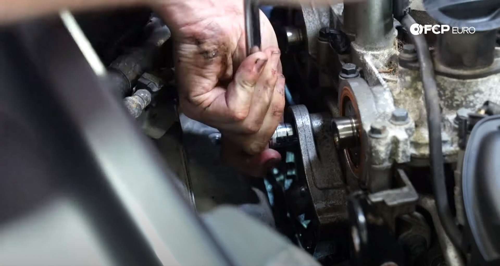 DIY Volvo P1 Water Pump Replacement removing the bolts from the front of the bracket