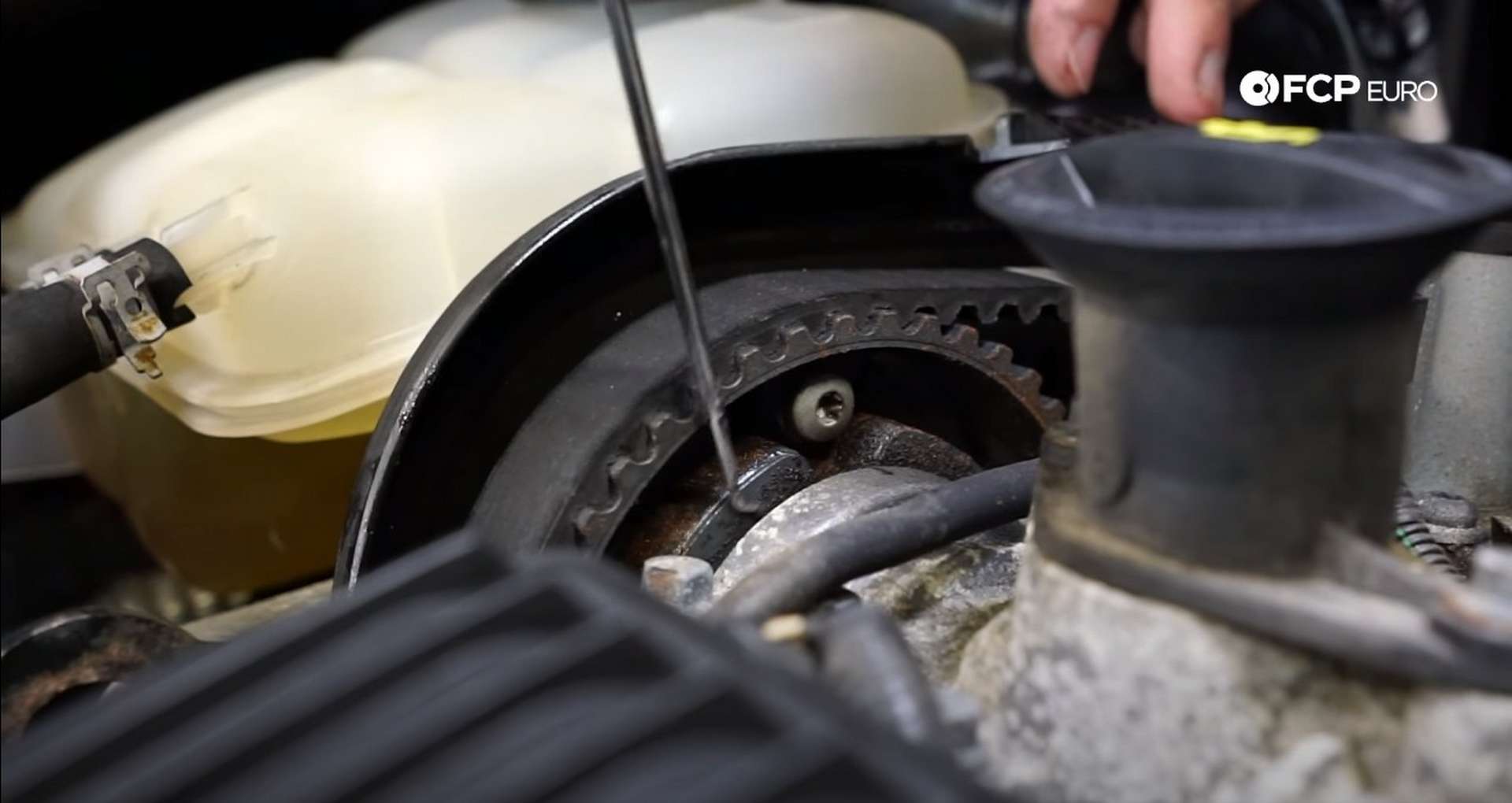 DIY Volvo P1 Timing Belt Replacement examining the oil residue on the camshaft sprockets