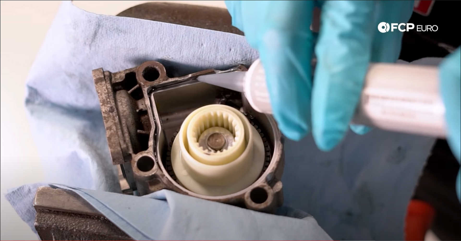 DIY BMW X3 Transfer Case Actuator applying sealant for the faceplate