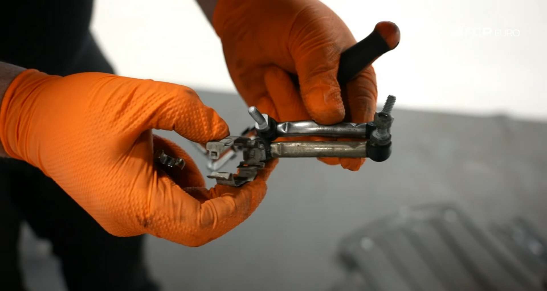DIY BMW E9X Front Control Arm Upgrade comparing headlight arms