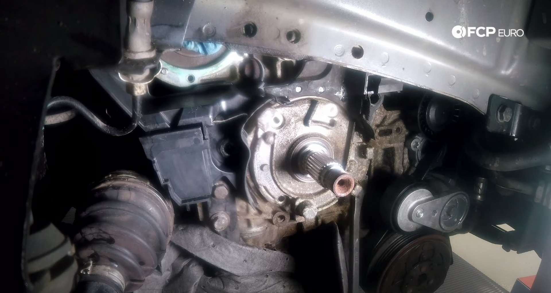 DIY Volvo P1 Timing Belt Replacement prying the oil pump off of the engine