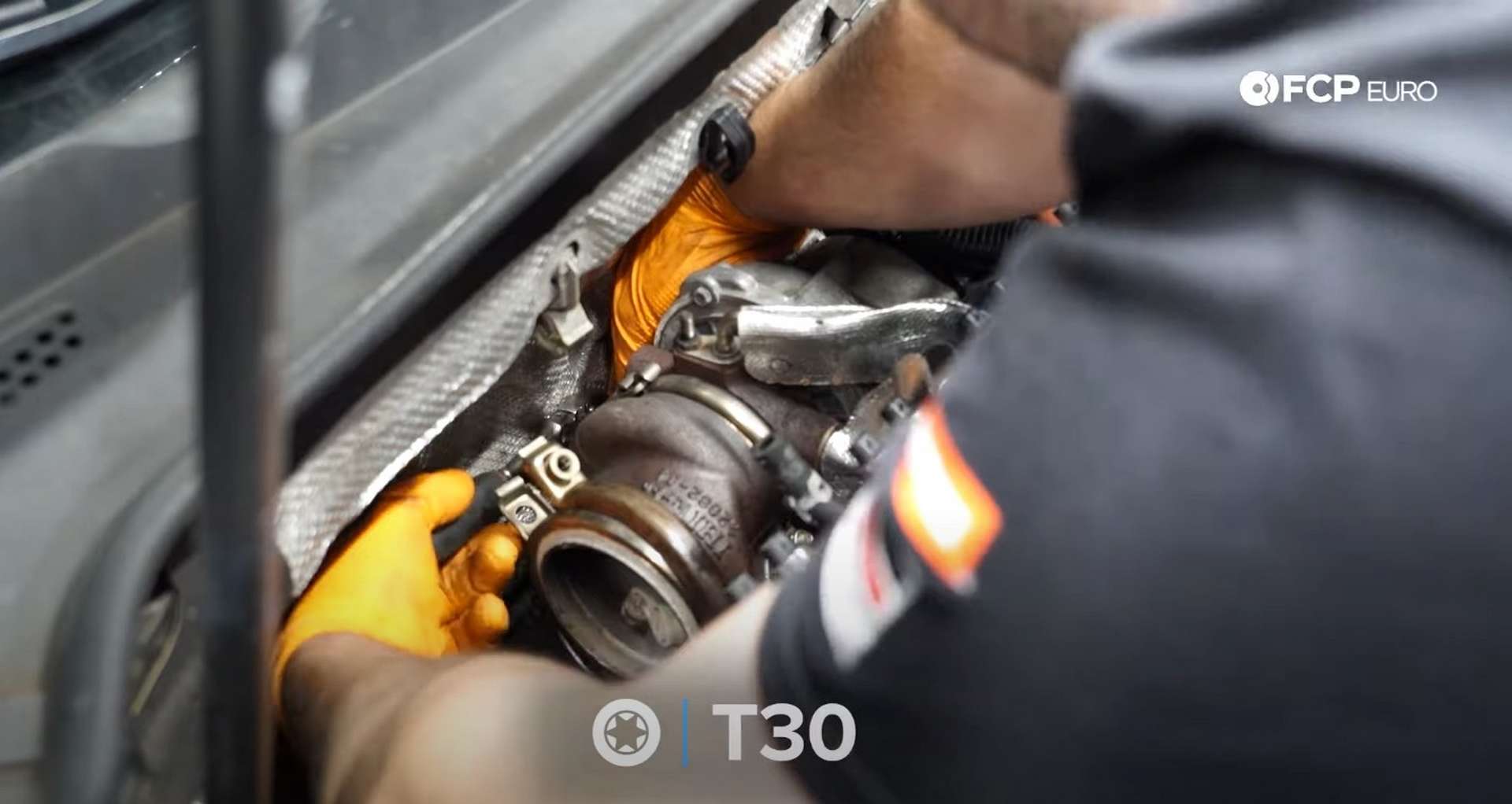 DIY MK7 VW GTI Turbocharger Upgrade reaching around the turbo to remove the coolant line