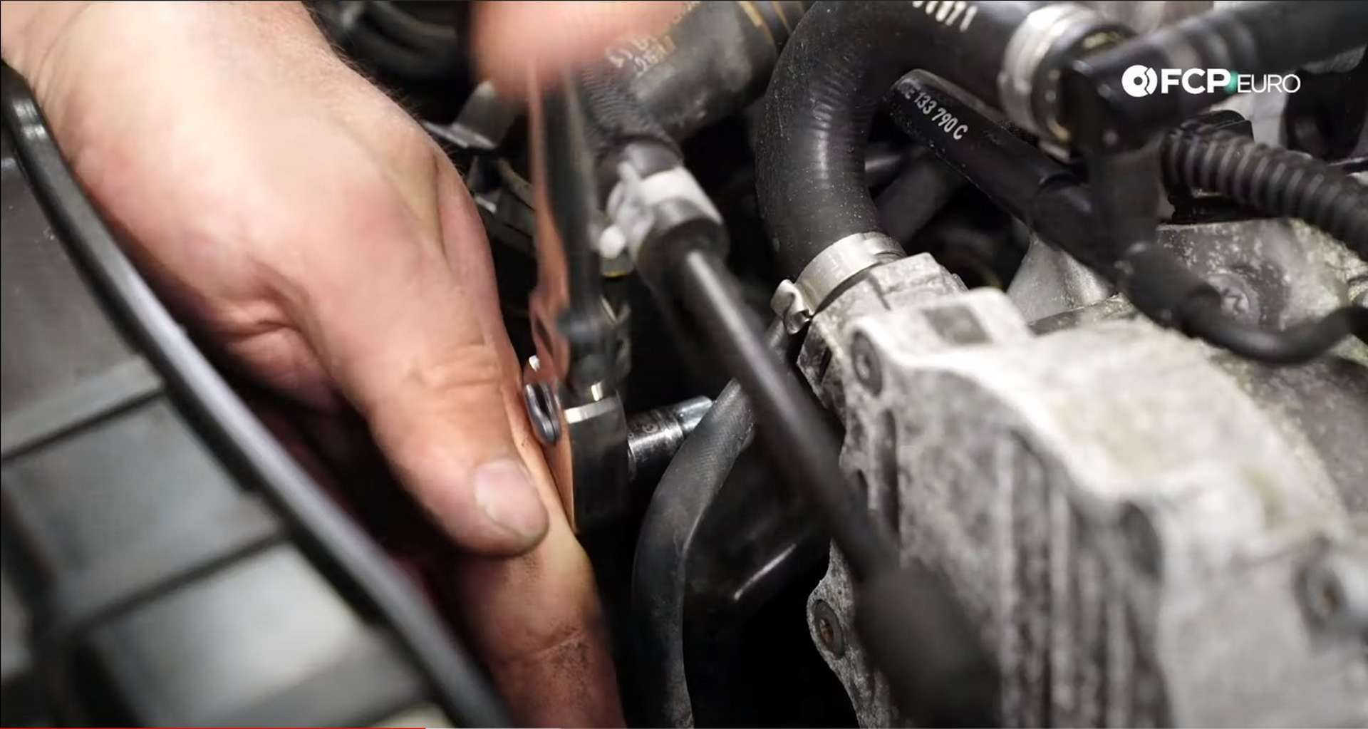 DIY Audi B8.5 Water Pump and Thermostat Replacement removing the T30 fastener front he coolant line