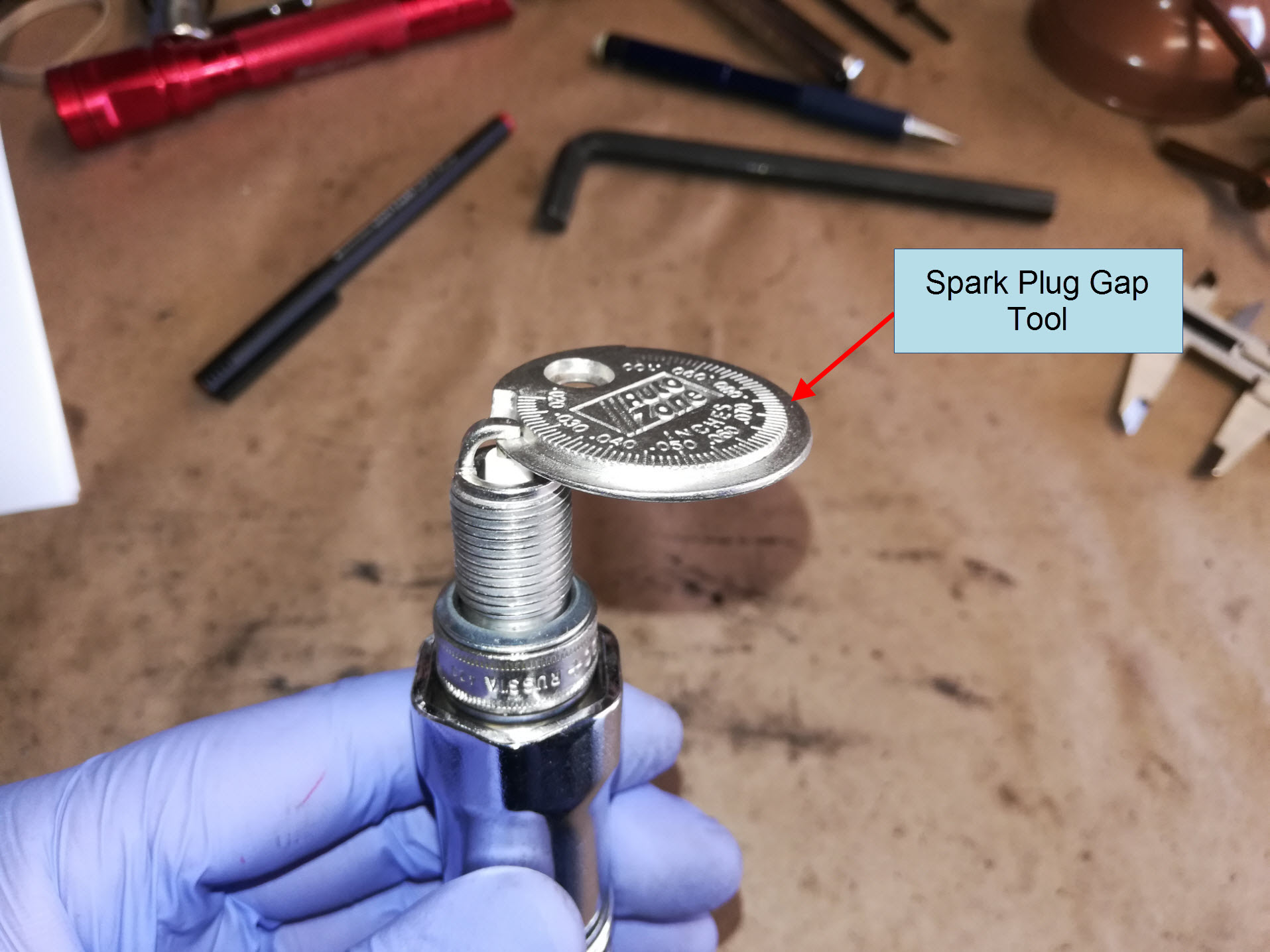 Air-cooled Porsche 911 spark plug gapping.