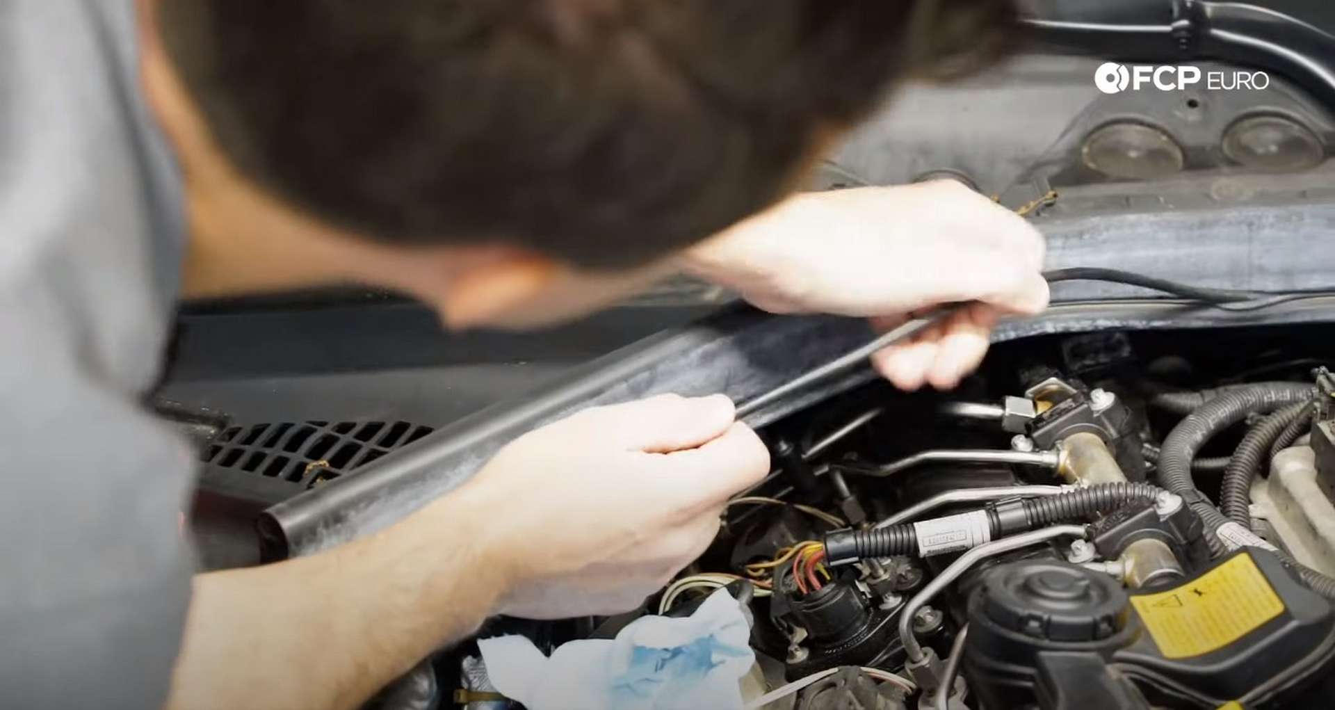 DIY BMW N20 Vacuum Pump removing the wire from the cowl seal