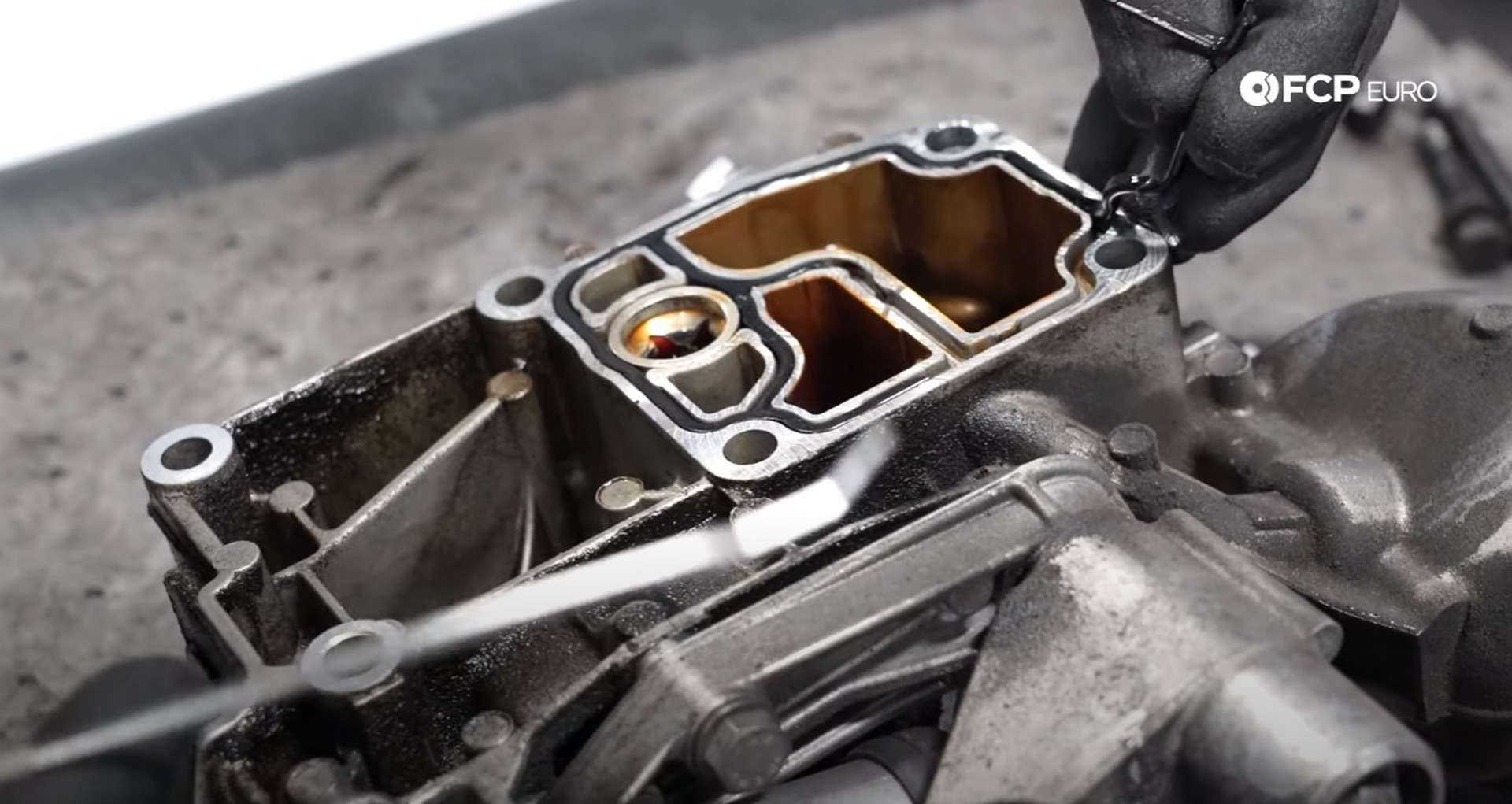 DIY BMW E46 Oil Filter Housing Gasket and VANOS Line Replacement removing the old oil filter housing gasket
