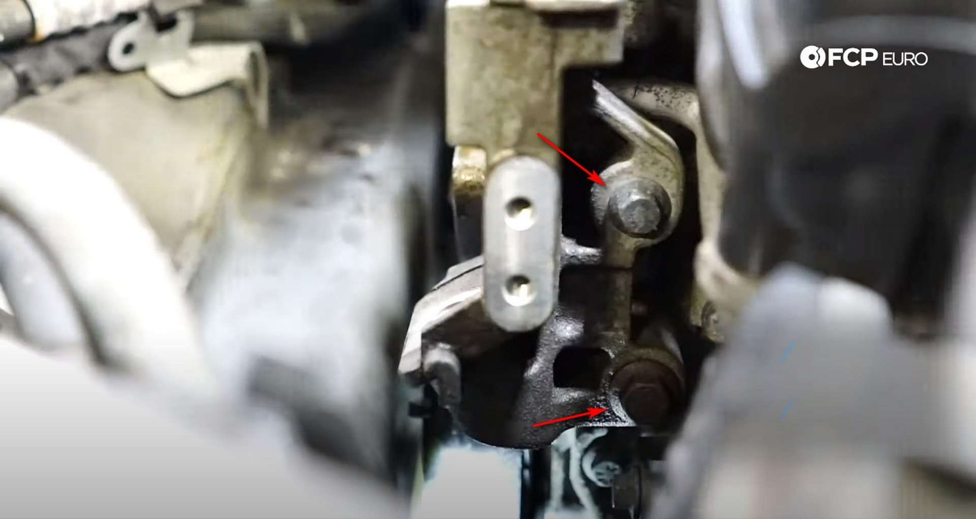 DIY Volvo P1 Water Pump Replacement removing the bolts from the side of the bracket