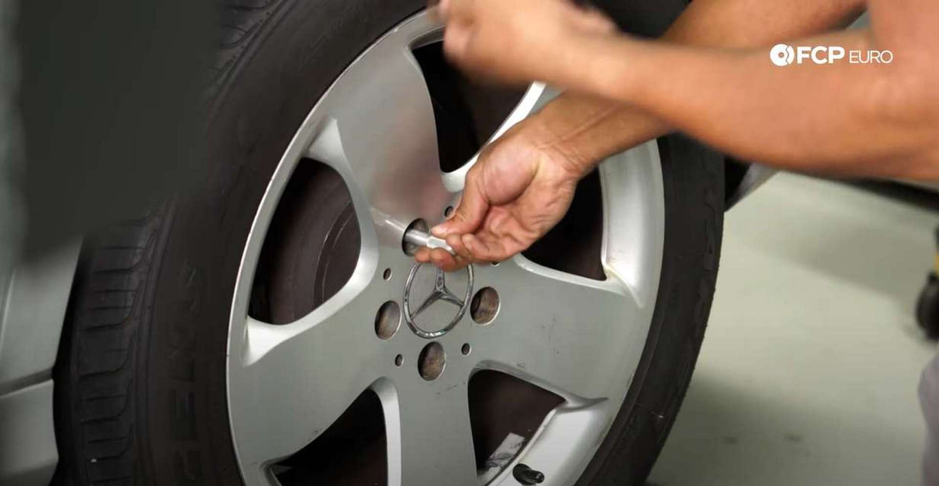 DIY Mercedes AIRMATIC Spring Replacement using the wheel hangar to install the wheel bolts