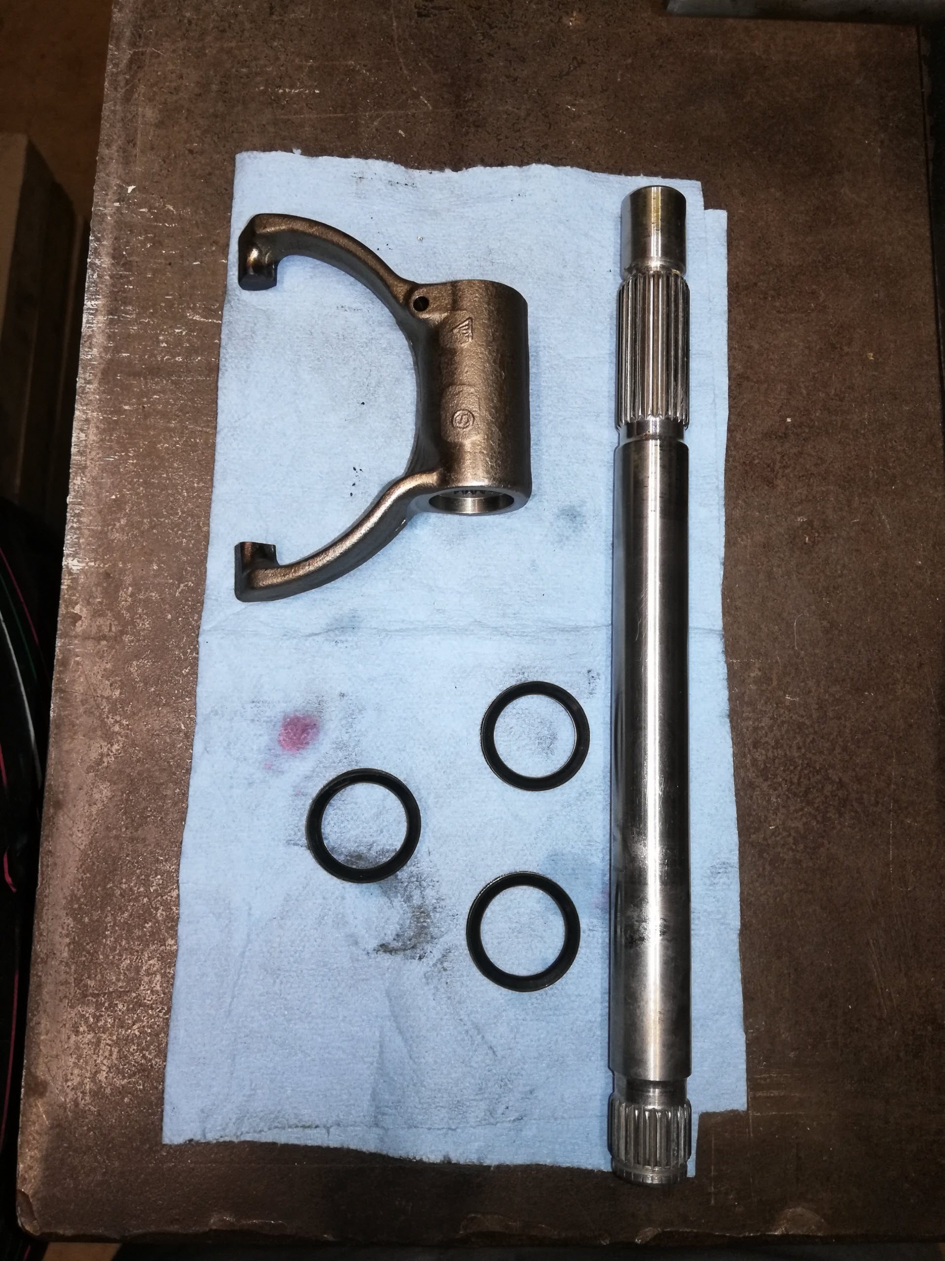 Air-cooled Porsche 911 clutch release fork, shaft, and dust seals.