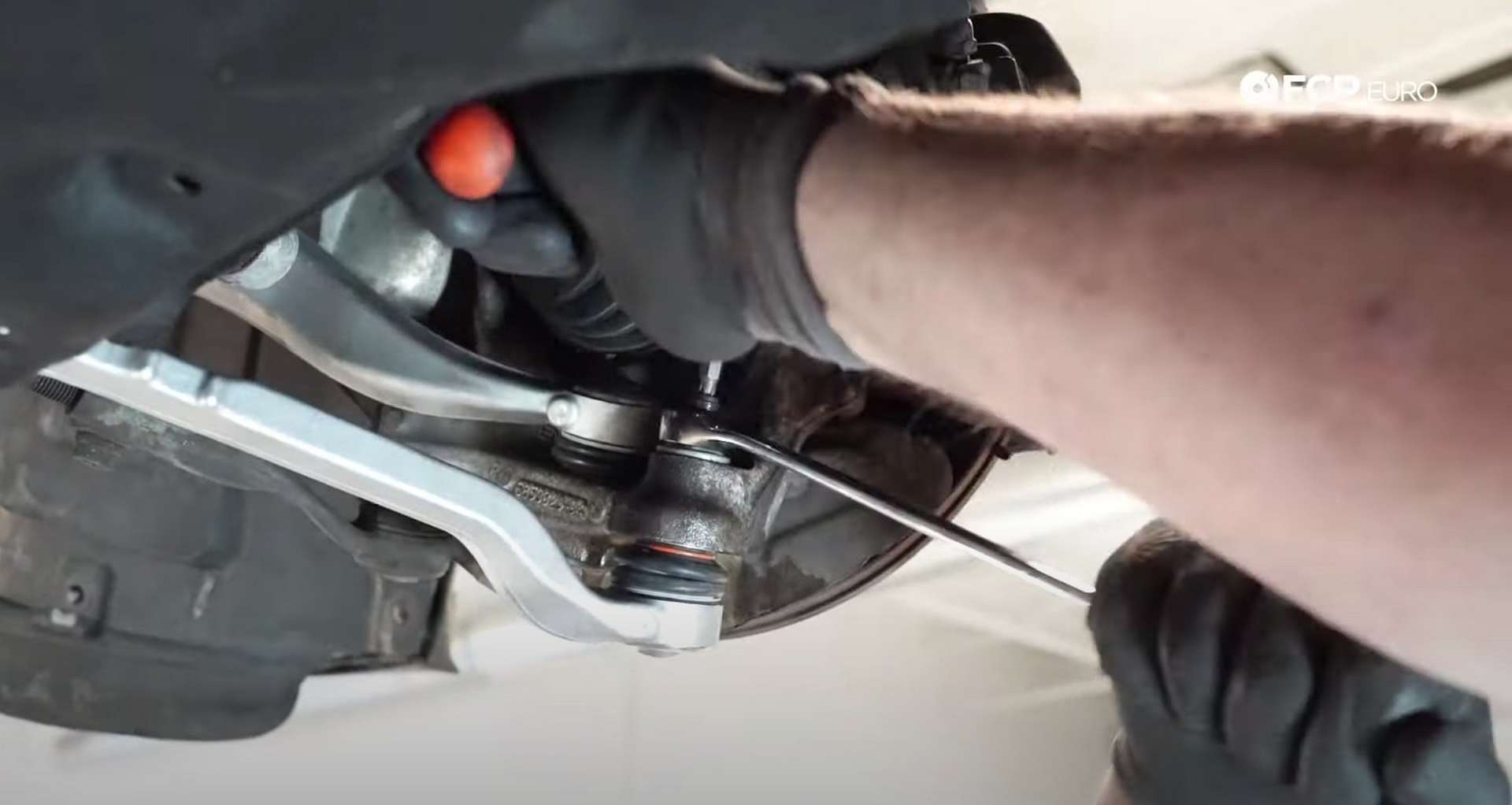 DIY BMW F30 Front Control Arm Replacement tightening the lower arm's ball joint nut