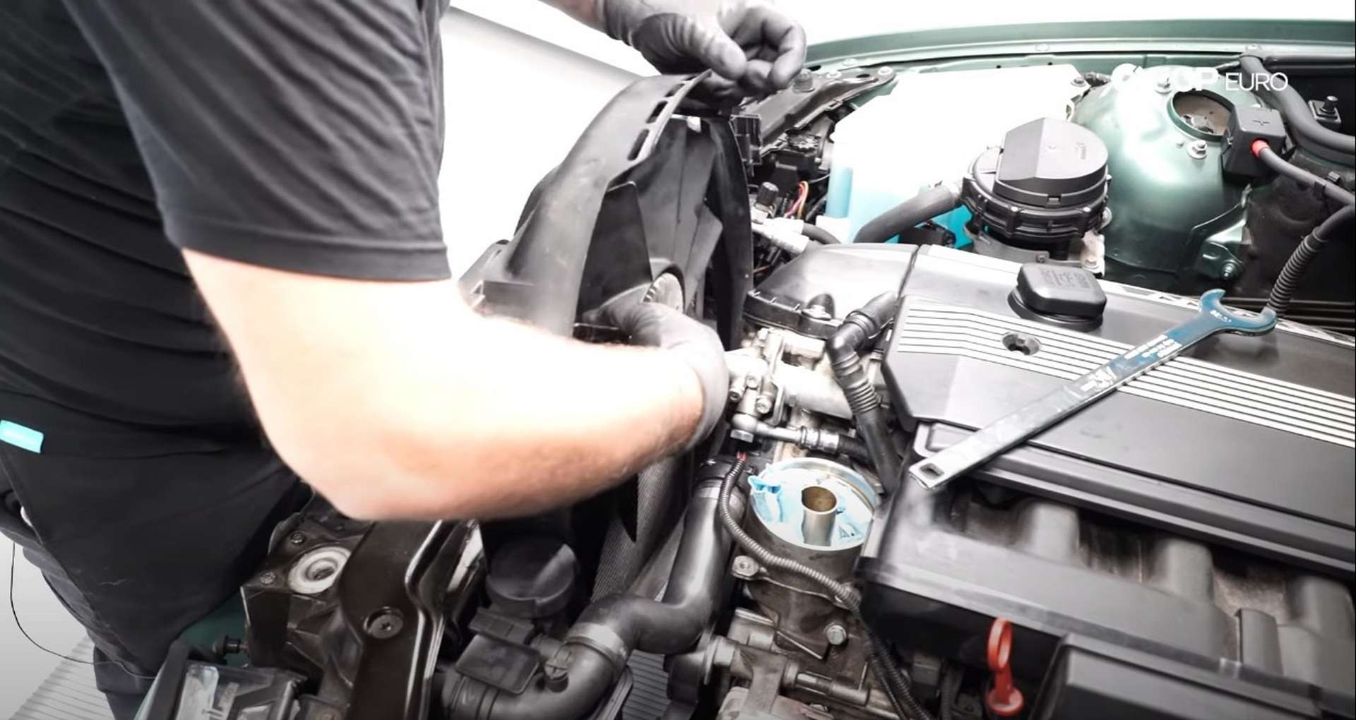 DIY BMW E46 Oil Filter Housing Gasket and VANOS Line Replacement installing the fan assembly