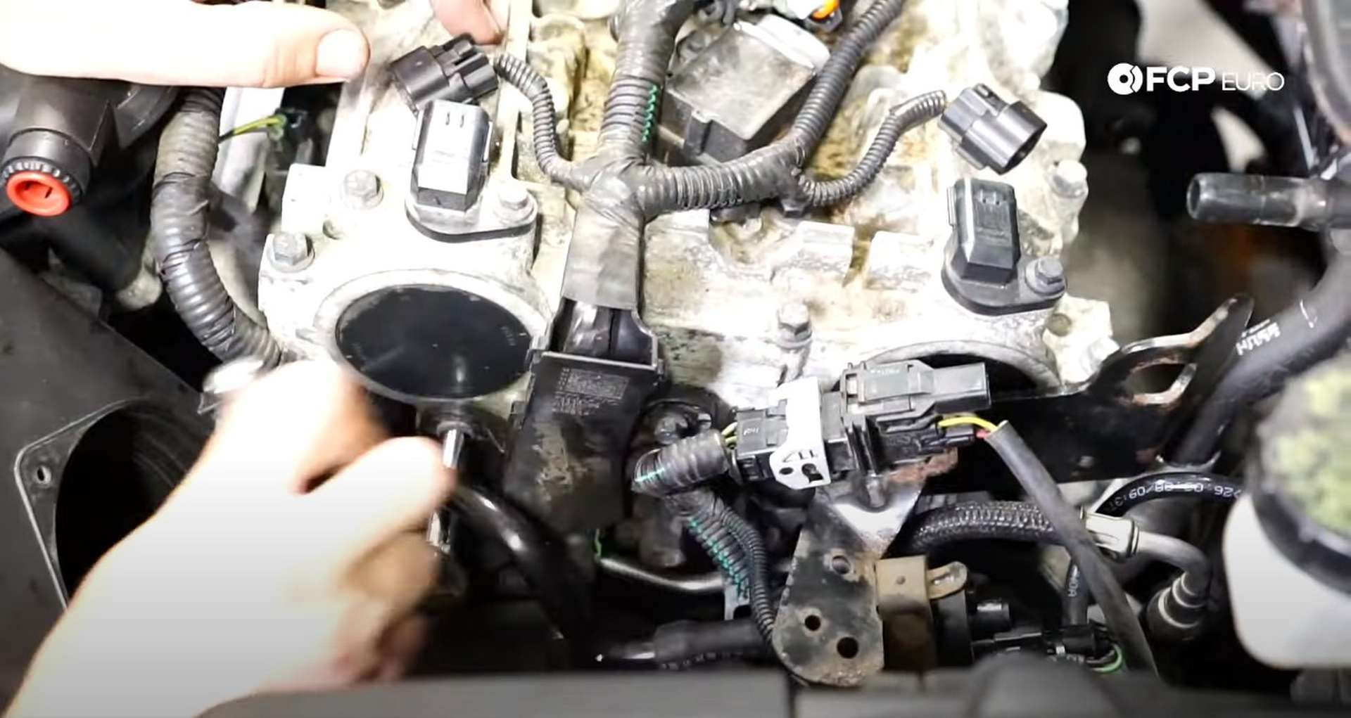 DIY Volvo P1 Timing Belt Replacement reattaching the ignition coil harness to the cylinder head