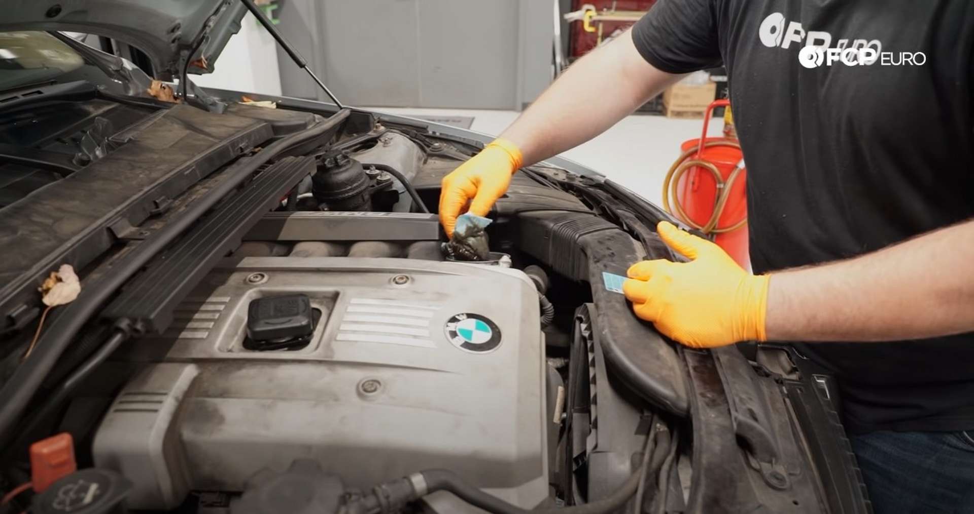 DIY BMW E9X Oil Filter Gasket Replacement filling the oil filter housing with rags