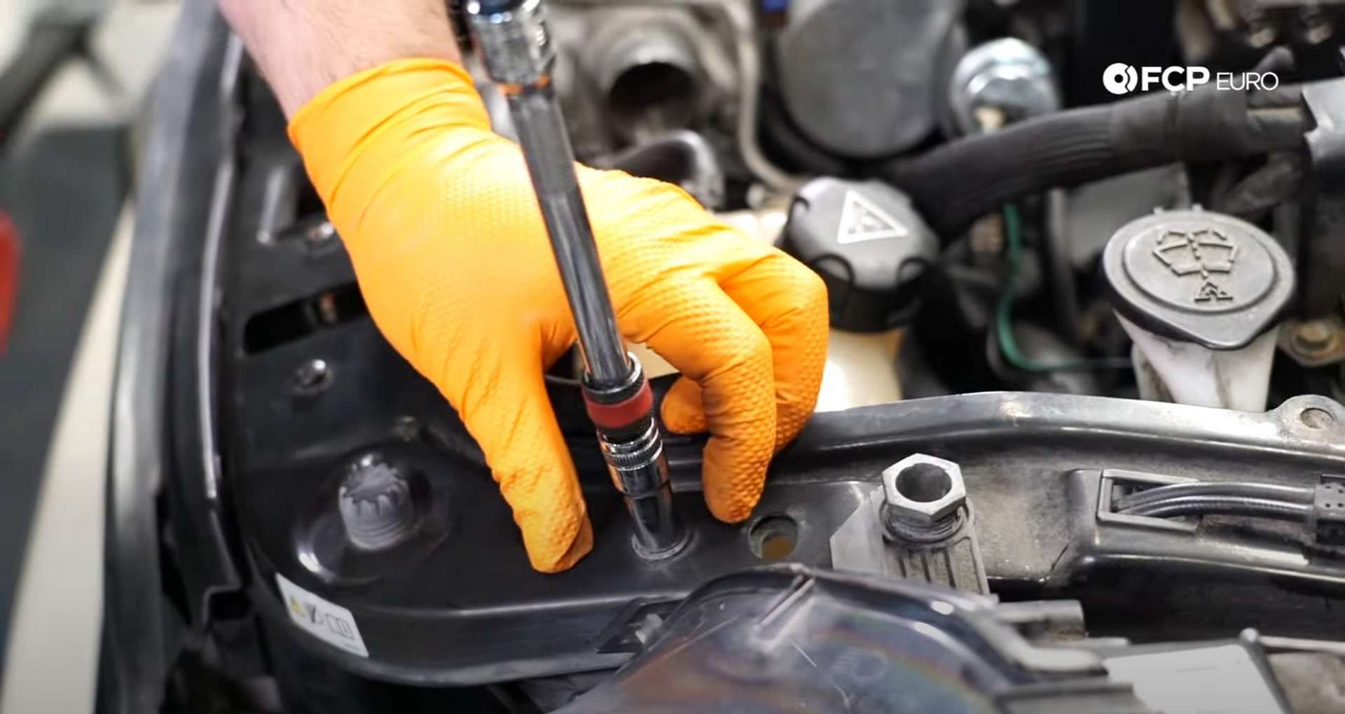 DIY MINI R56 Timing Chain Replacement removing the 10mm bolts from the U-brace