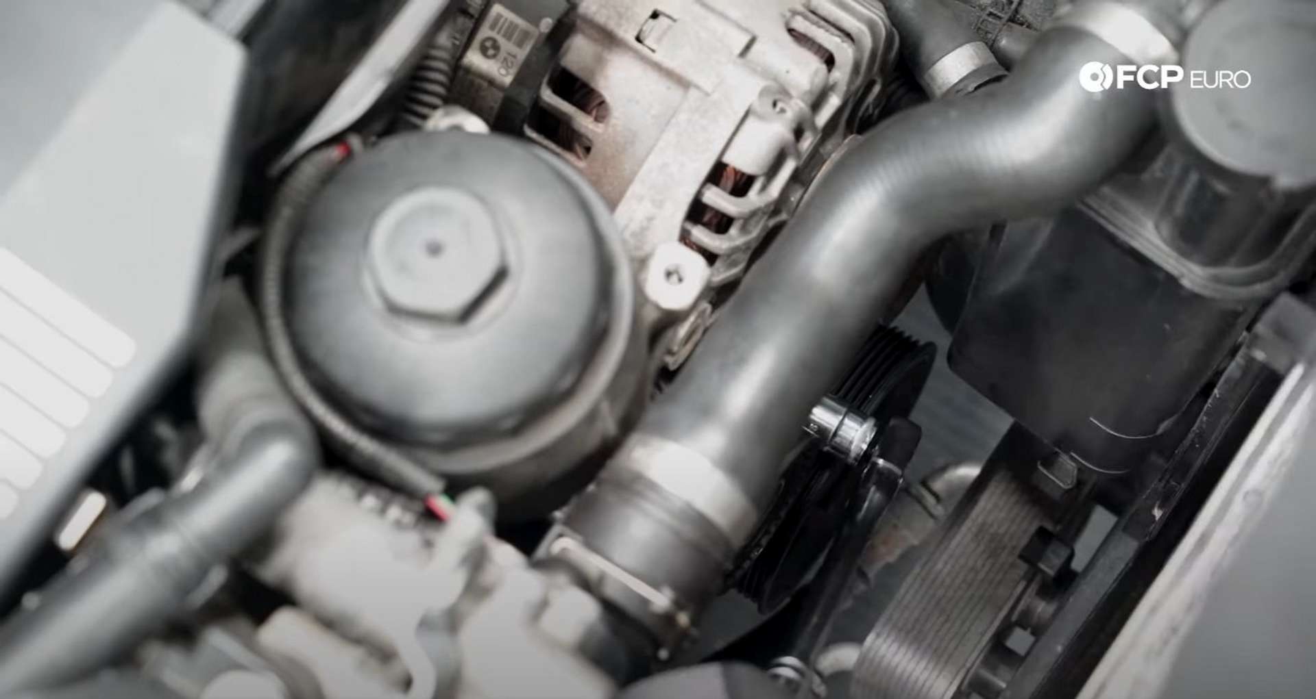 DIY BMW E46 Oil Filter Housing Gasket and VANOS Line Replacement removing the last alternator mounting bolt