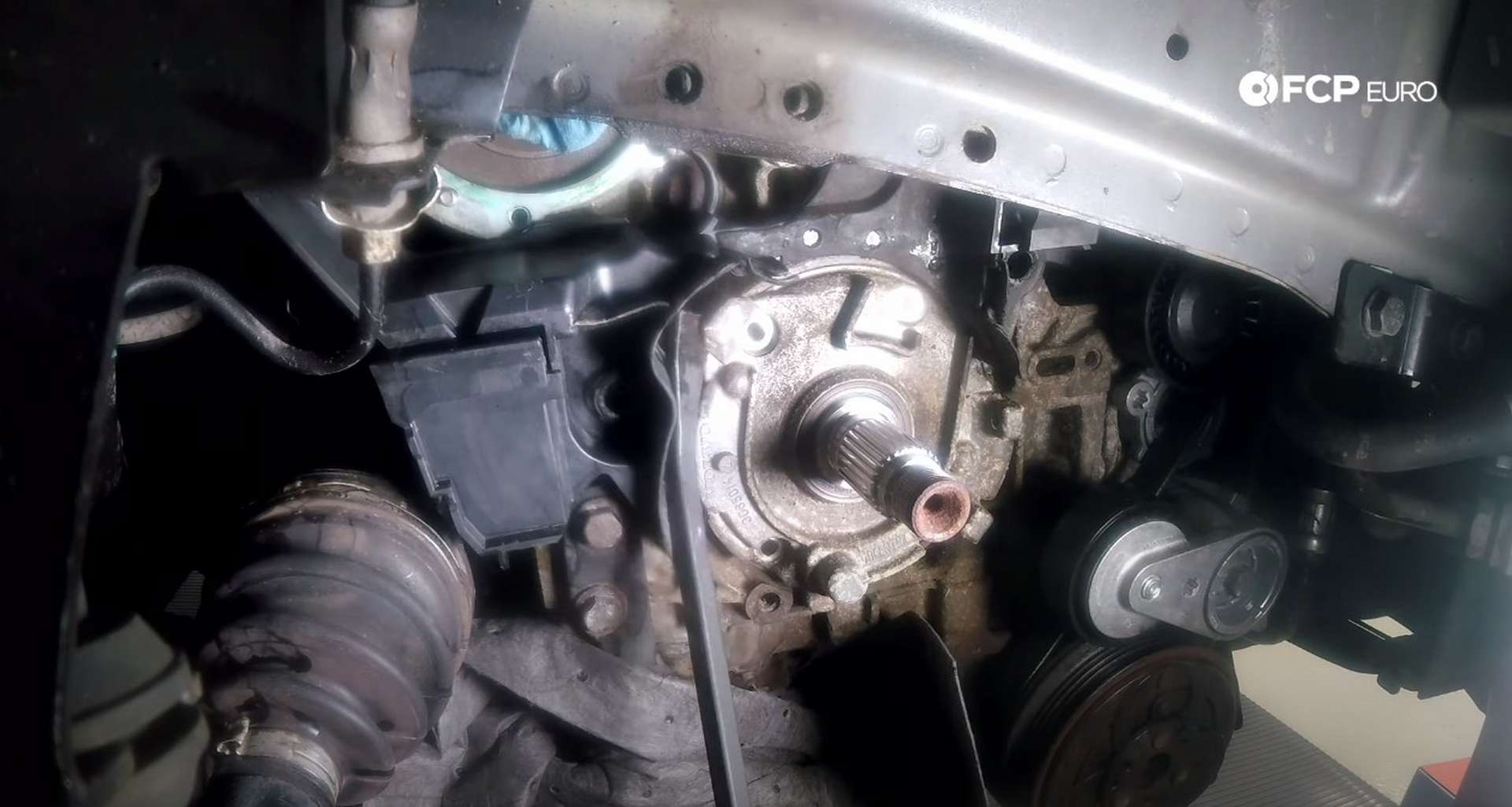 DIY Volvo P1 Timing Belt Replacement prying the oil pump off of the engine