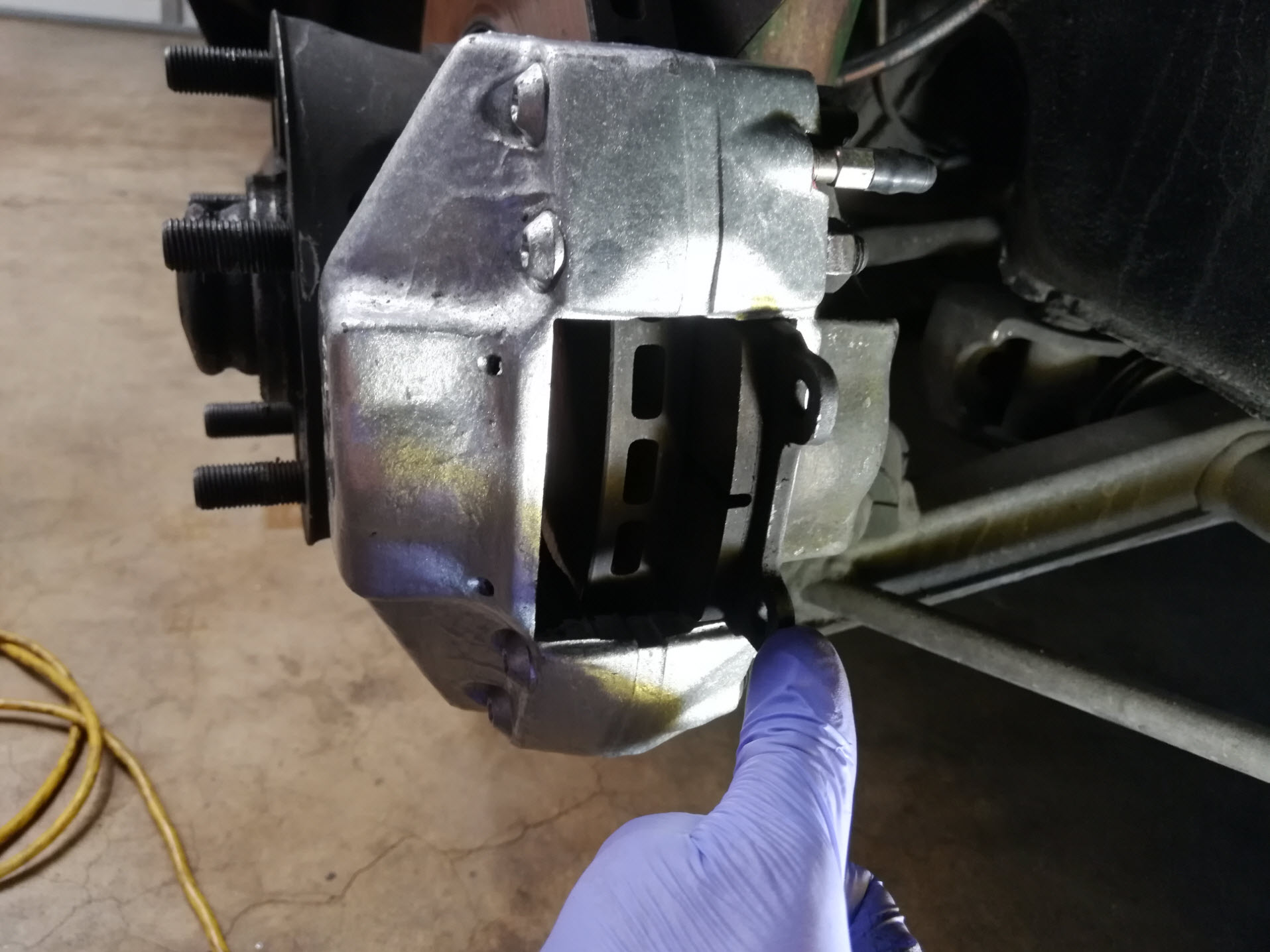 Air-cooled Porsche 911 brake caliper installation.