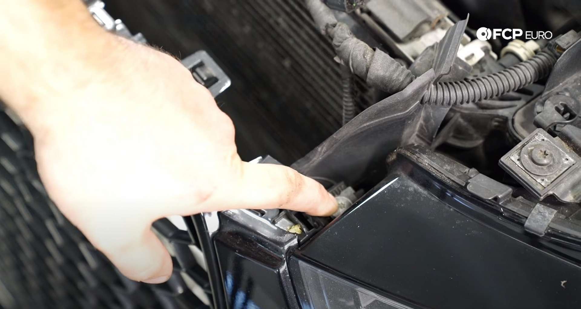 DIY Audi B8.5 Water Pump and Thermostat Replacement removing the fastener next to the headlight