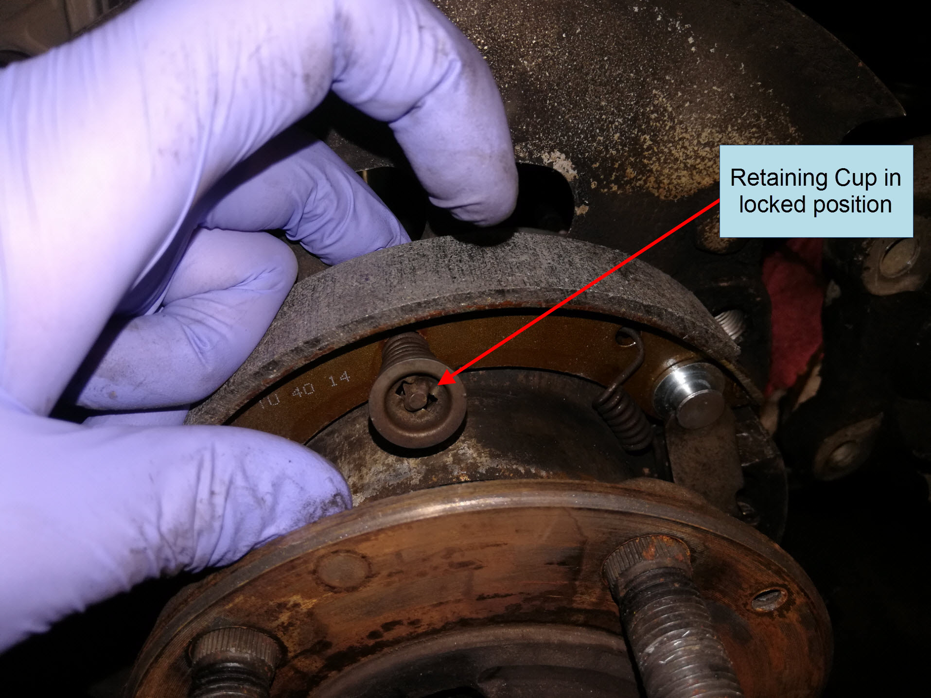 Air-cooled Porsche 911 parking brake spring reassembly.