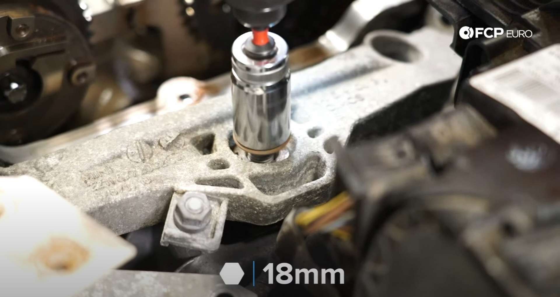 DIY MINI R56 Timing Chain Replacement removing the 18mm nut on the engine mount bracket