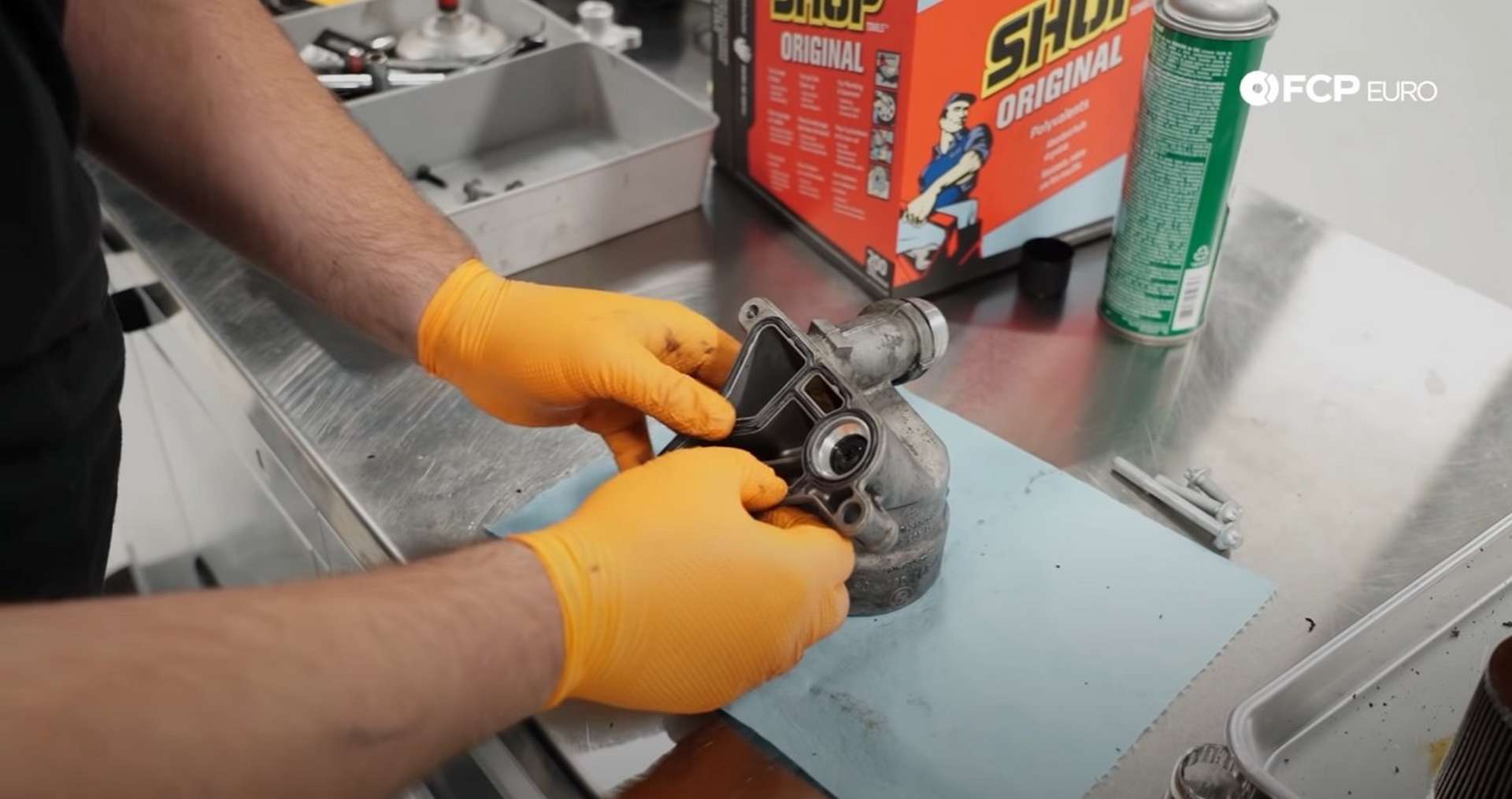 DIY BMW E9X Oil Filter Gasket Replacement pressing in the new oil filter housing gasket