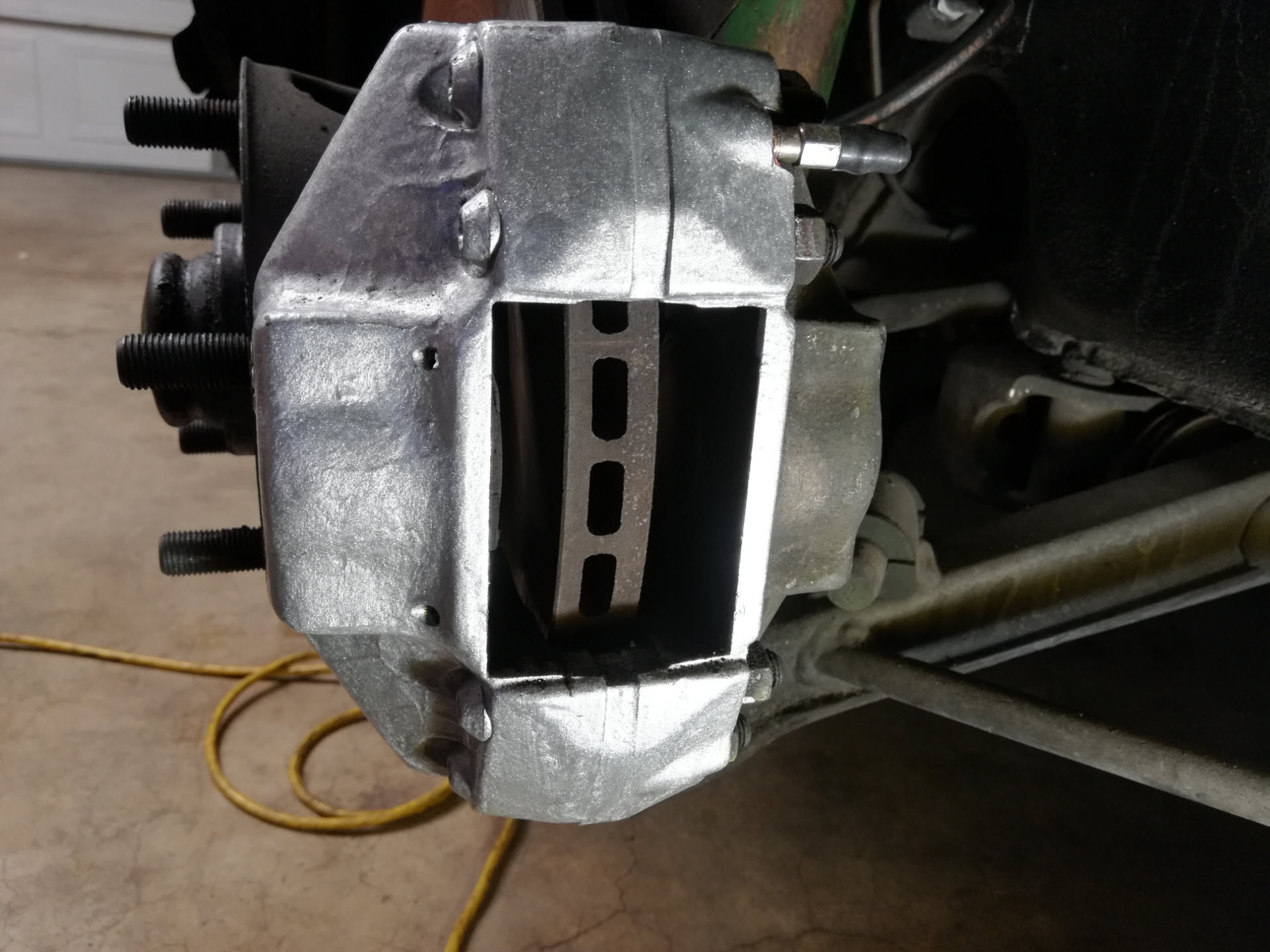 Air-cooled Porsche 911 brake caliper with no pads.