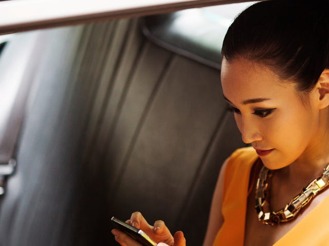woman attending an online intensive class on her phone in the car