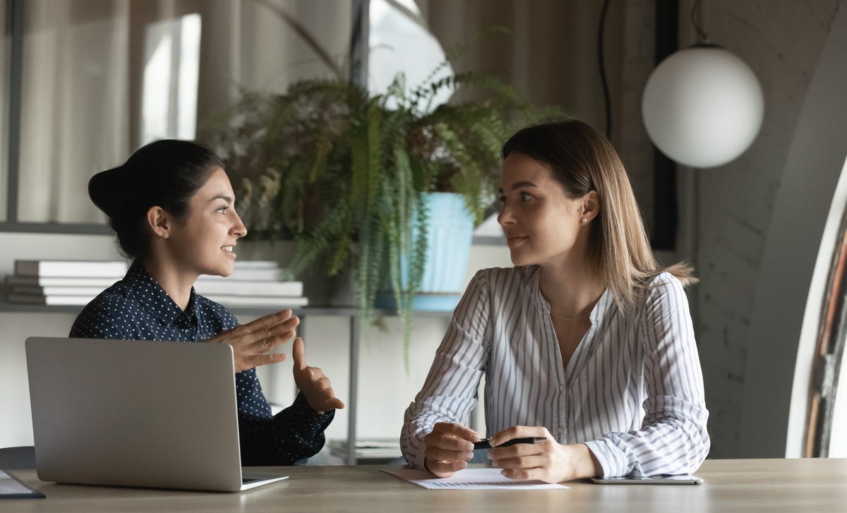 Instructor talking to her student and smiling at her during a French lesson in Regina