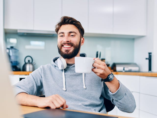 man drinking coffee and learning with his online intensive classes on his computer from home